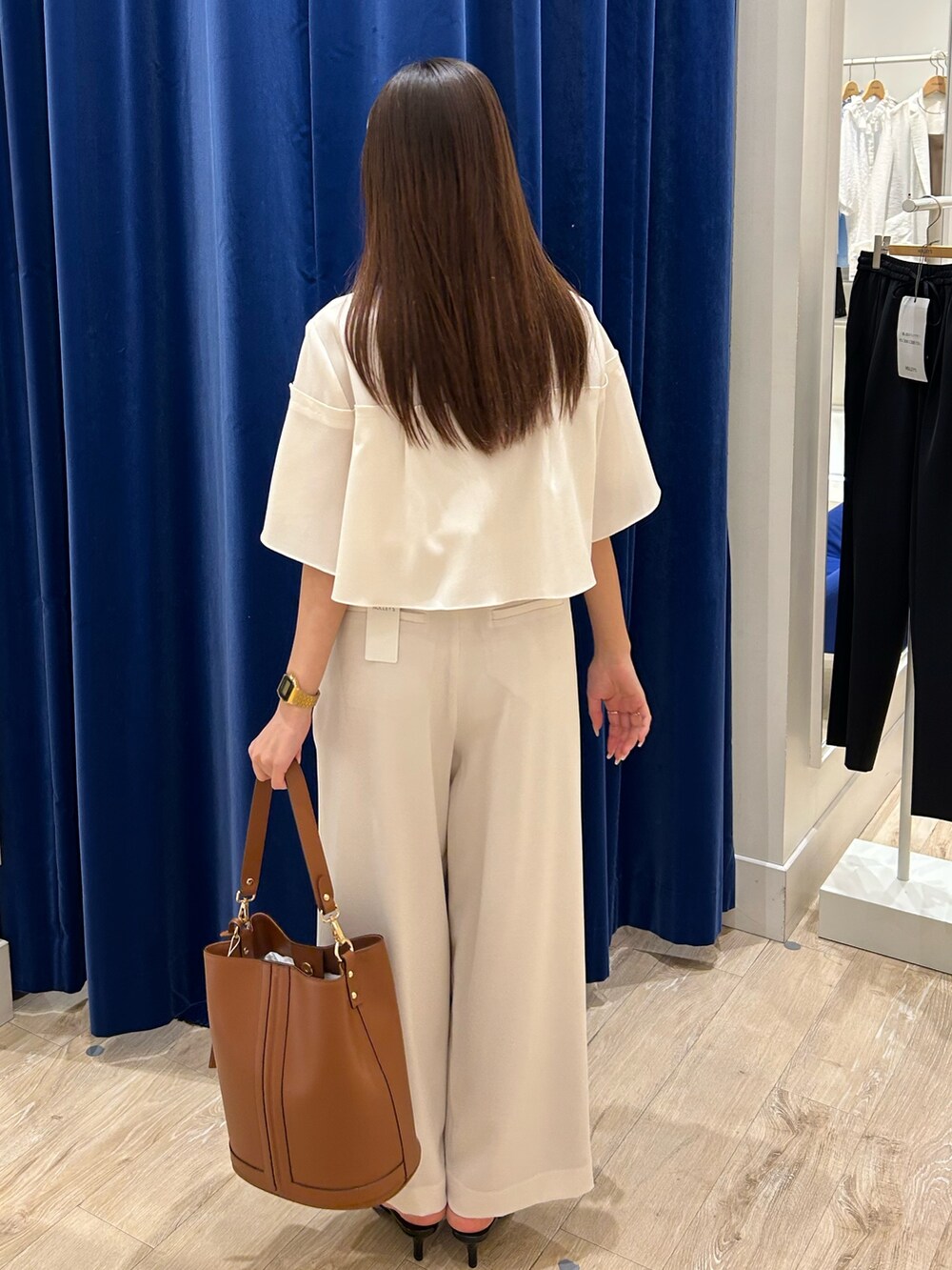 ホワイト系のシャツ/ブラウス、ホワイト系のその他パンツ、ブラウン系のショルダーバッグを着用したレディースの春コーディネートの3枚目の写真