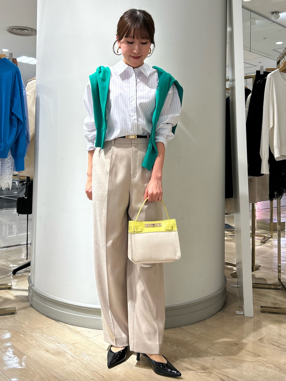 イエロー系のショルダーバッグ、ベージュ系のその他パンツ、グリーン系のカーディガン/ボレロを着用したレディースの春コーディネートの2枚目の写真