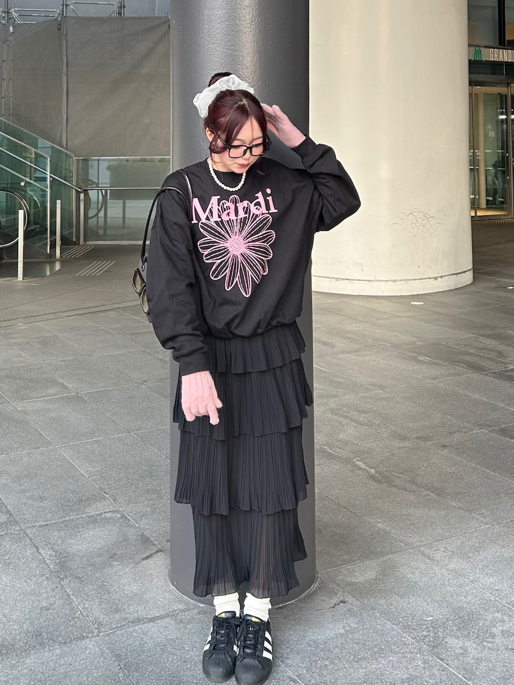 ブラック系のスウェット、ブラック系のスカート、ブラック系のスニーカーを着用したレディースの冬コーディネートの2枚目の写真