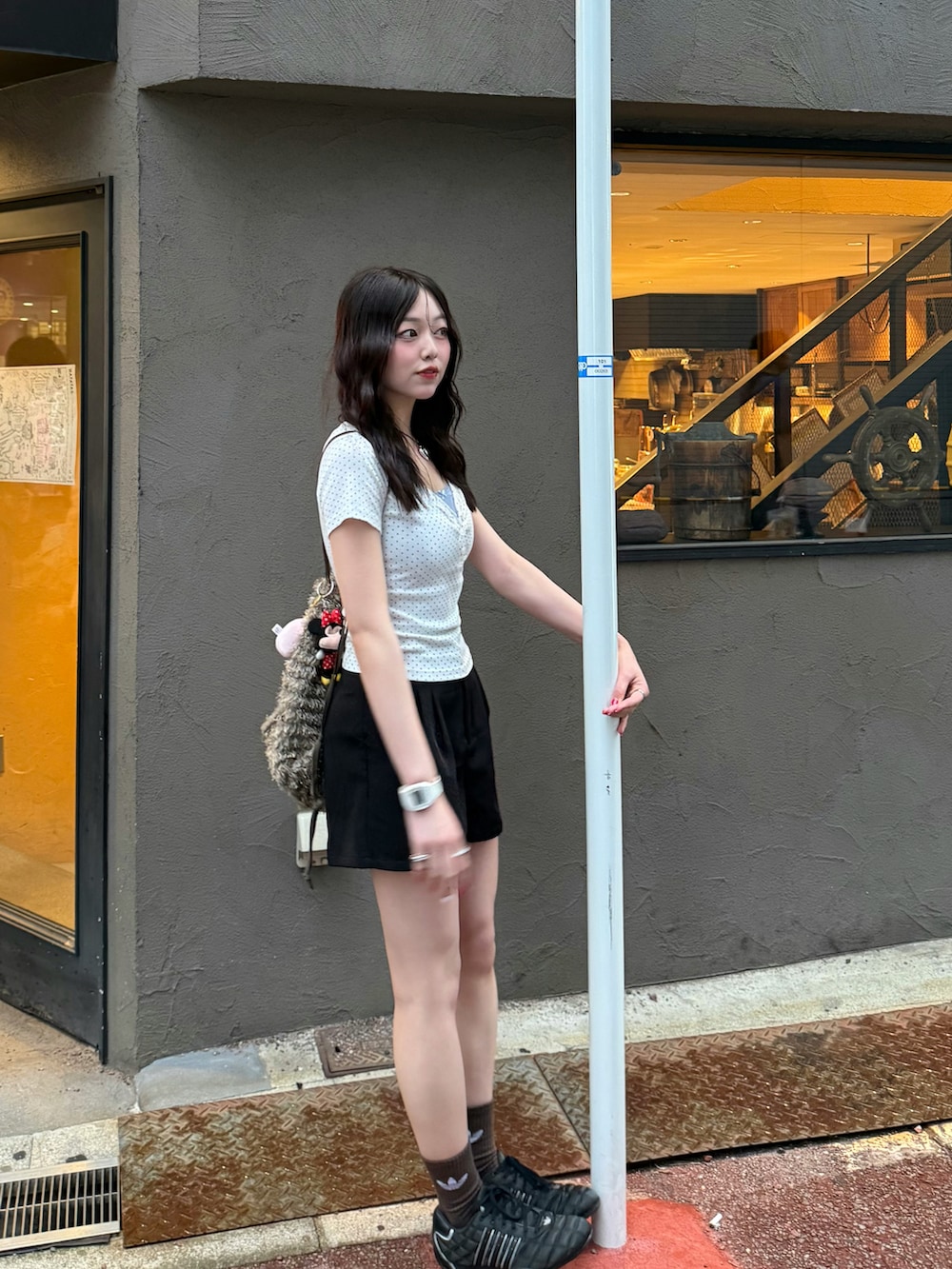 ホワイト系のTシャツ/カットソー、グリーン系のバックパック/リュック、ブラック系のパンツを着用したレディースの夏コーディネートの2枚目の写真