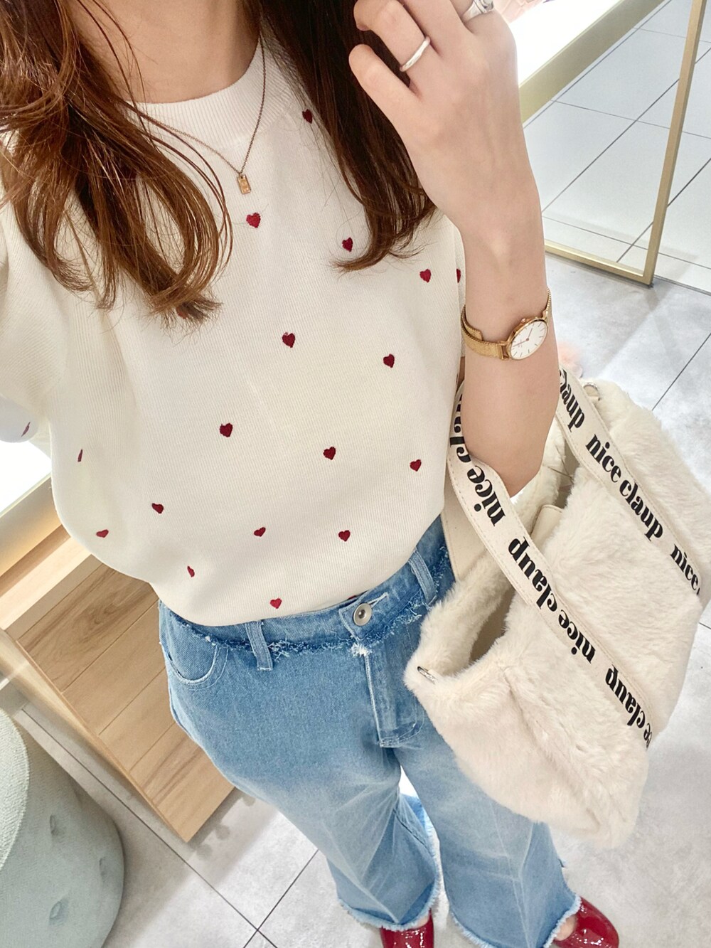 ホワイト系のトートバッグ、レッド系のバレエシューズ、ブルー系のデニムパンツを着用したレディースの夏コーディネートの3枚目の写真