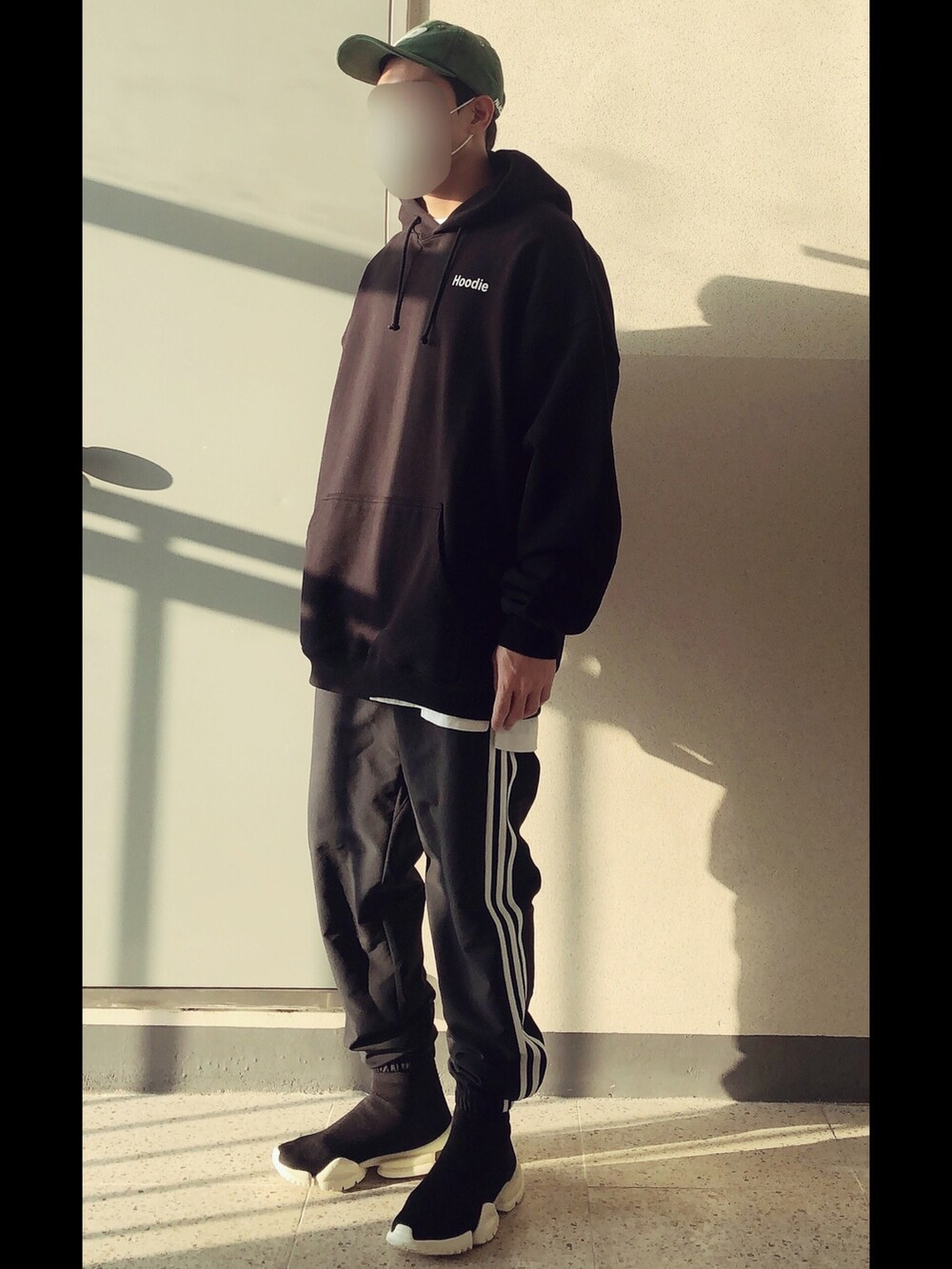 ブラック系のパーカー、ブラック系のパンツ、ブラック系のスニーカーを着用したメンズの秋コーディネートの2枚目の写真