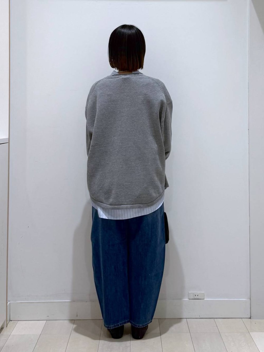 ブラック系のバレエシューズ、ブラック系のトートバッグ、グレー系のニット/セーターを着用したレディースの冬コーディネートの3枚目の写真