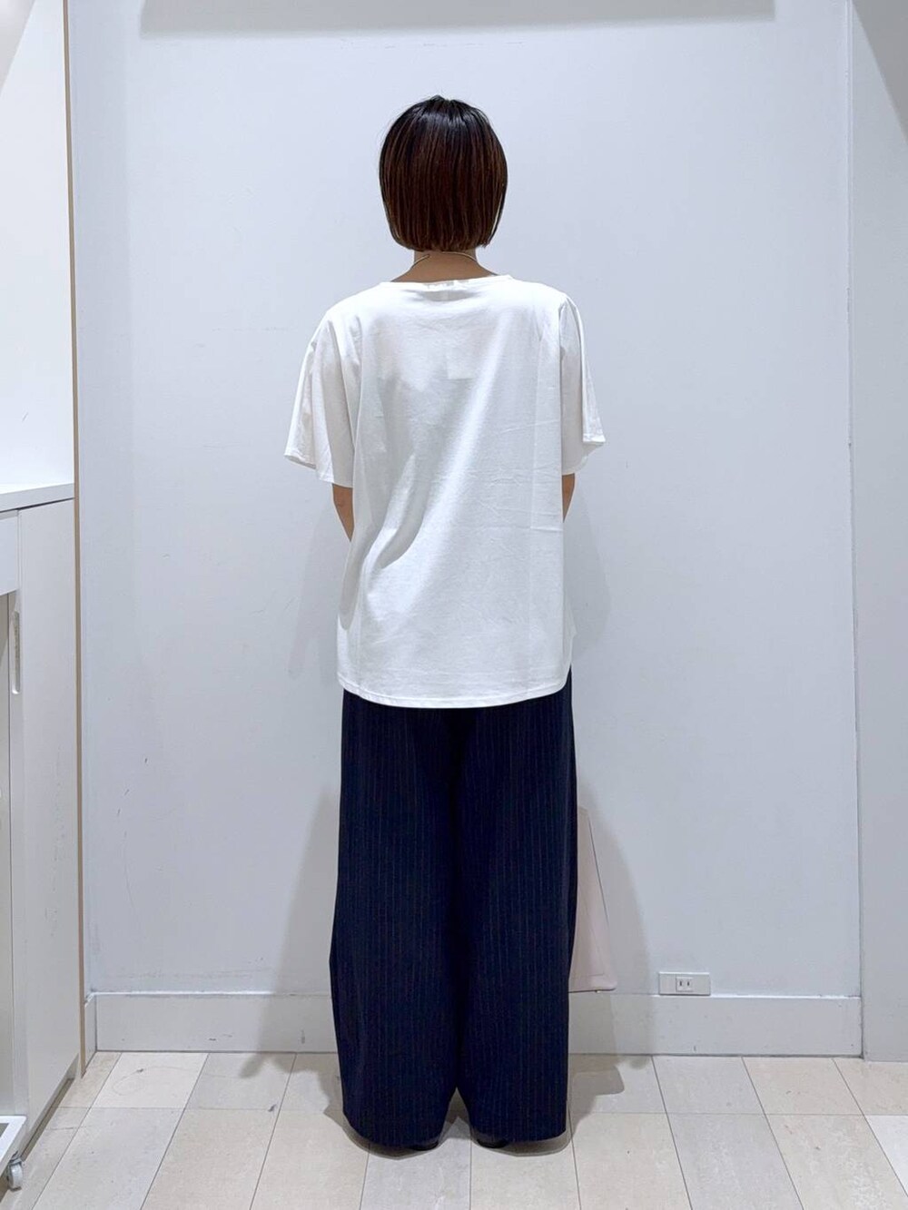 ブラック系のパンプス、ブルー系のその他パンツ、ホワイト系のTシャツ/カットソーを着用したレディースの夏コーディネートの3枚目の写真