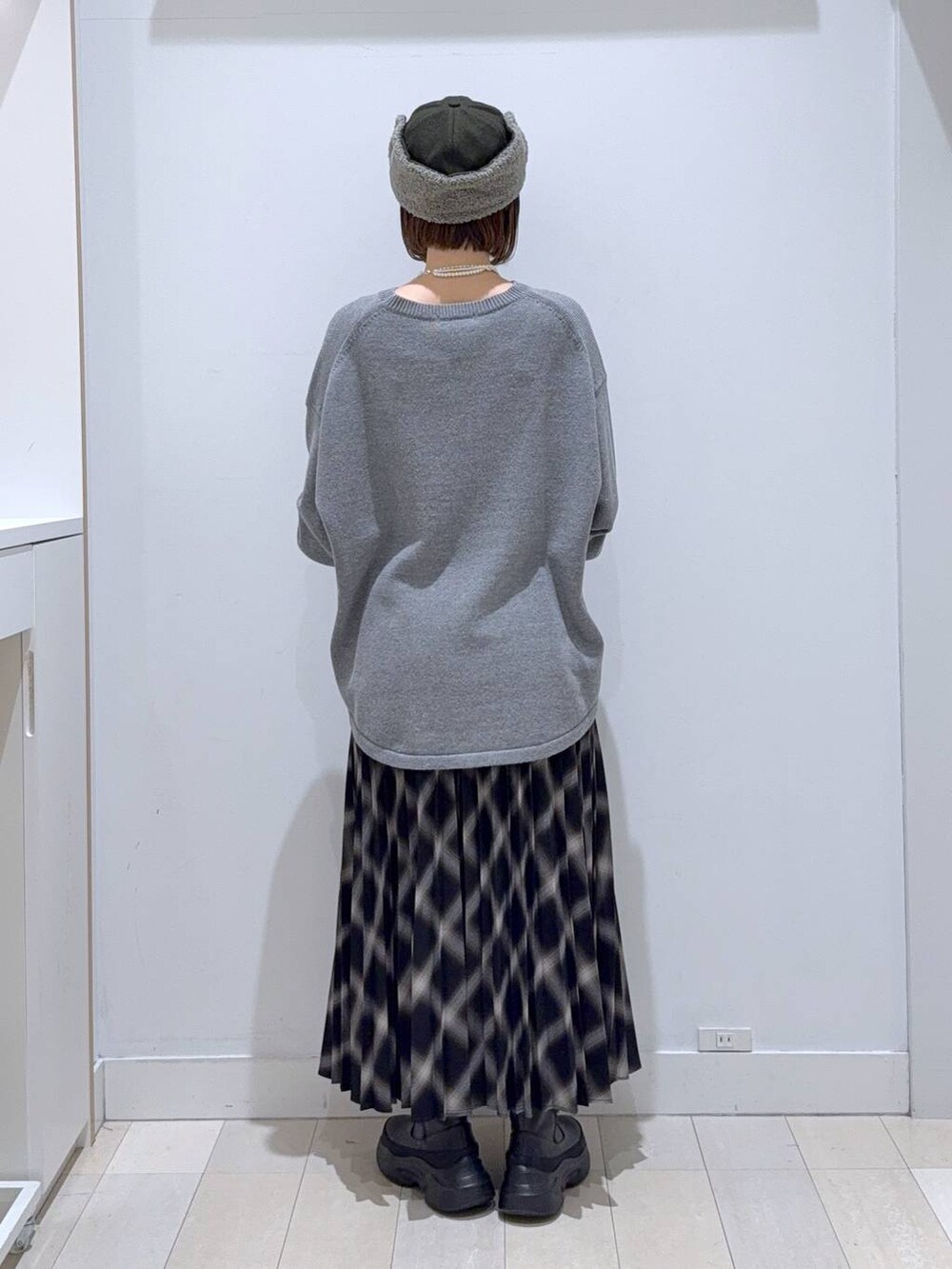 ブラック系のバックパック/リュック、グレー系のニット/セーター、ブラック系のブーツを着用したレディースの冬コーディネートの3枚目の写真