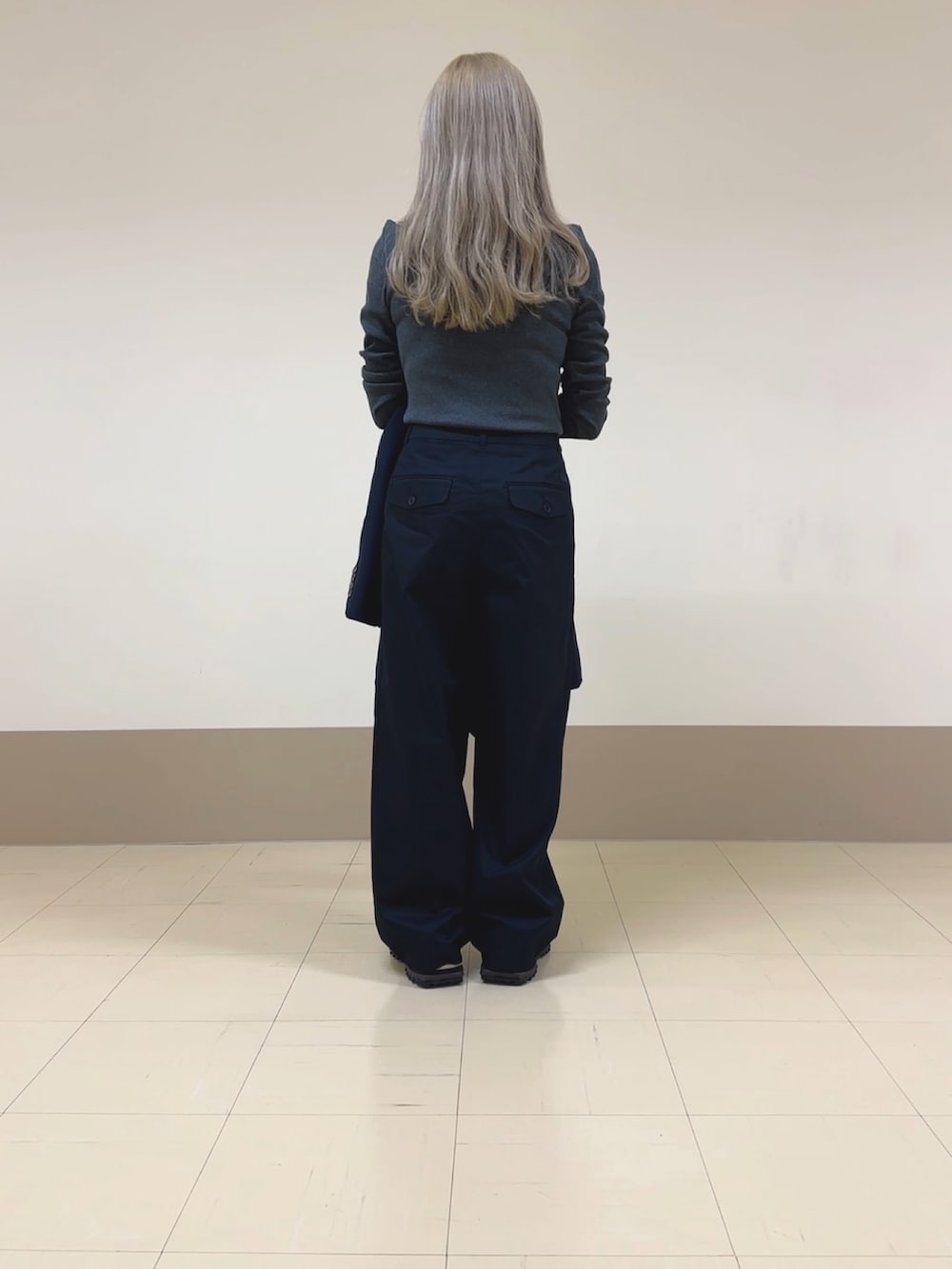 ブルー系のチノパンツ、グレー系のポロシャツ、ブルー系のテーラードジャケットを着用したレディースの秋コーディネートの3枚目の写真