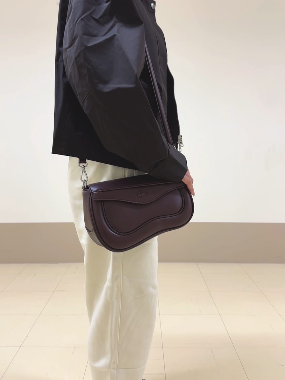ホワイト系のスウェットパンツ、ベージュ系のスニーカー、ブラウン系のショルダーバッグを着用したレディースの秋コーディネートの8枚目の写真