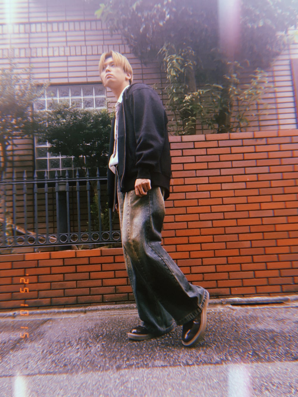 ブルー系のデニムパンツ、ブラック系のパーカー、ホワイト系のシャツ/ブラウスを着用したメンズの秋コーディネートの3枚目の写真