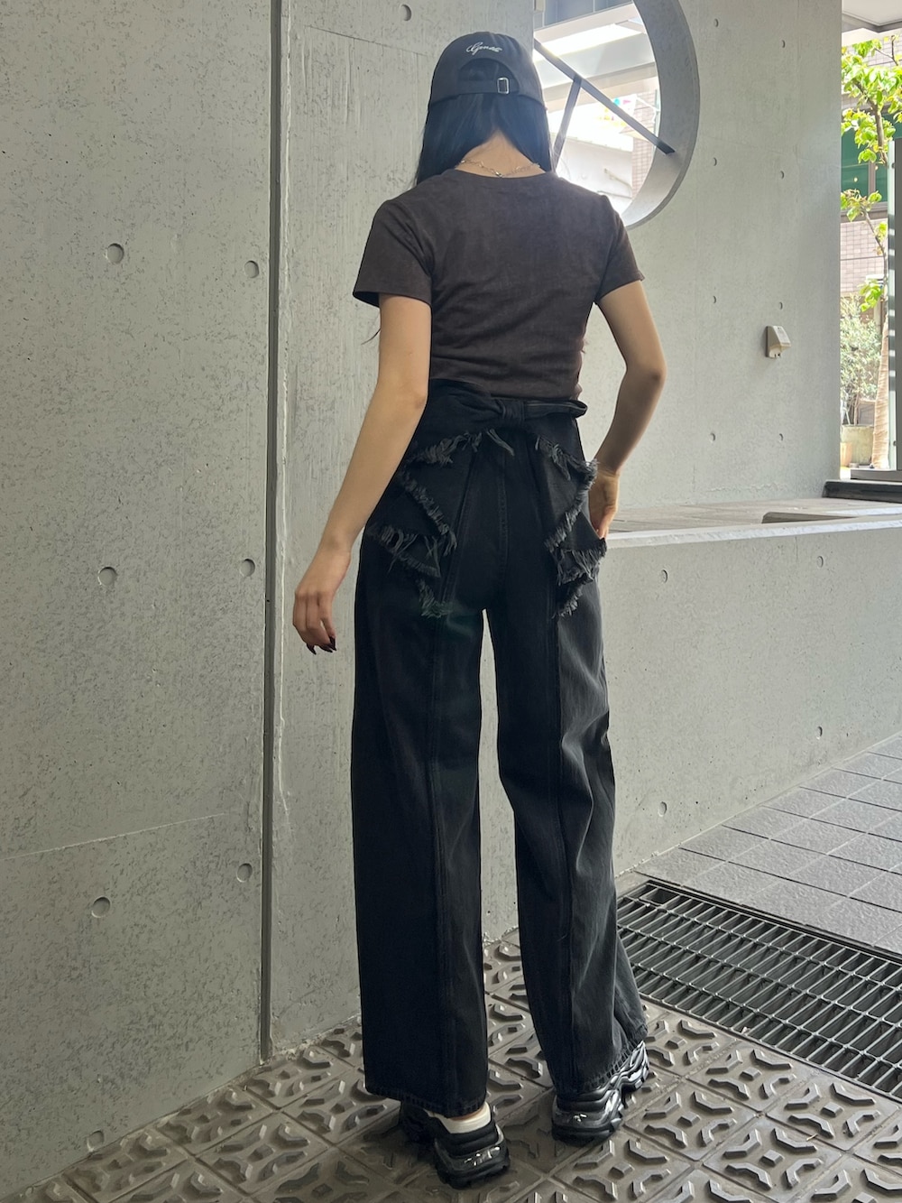 ブラウン系のTシャツ/カットソー、ホワイト系のサンダル、ブラック系のデニムパンツを着用したレディースの夏コーディネートの3枚目の写真