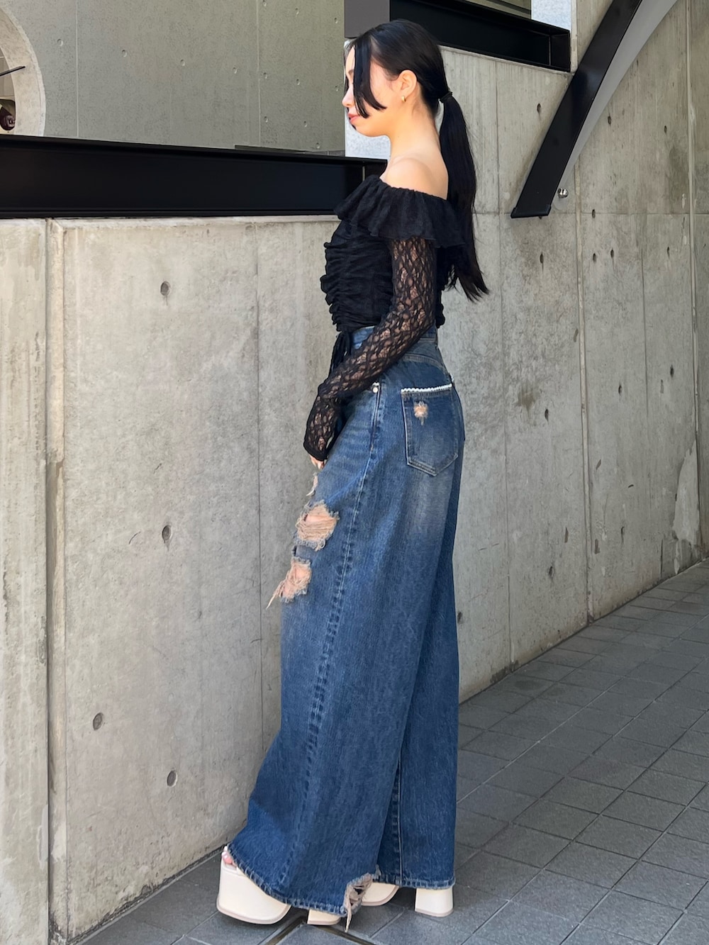 ブラック系のTシャツ/カットソー、ブルー系のデニムパンツ、ホワイト系のサンダルを着用したレディースの冬コーディネートの2枚目の写真