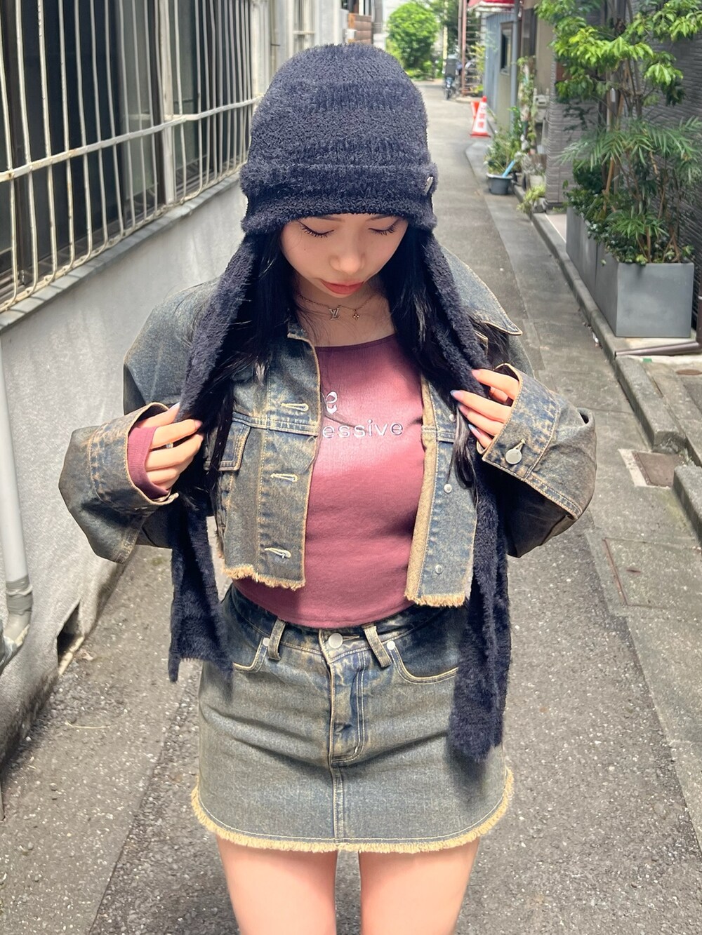 ブルー系のデニムジャケット、レッド系のTシャツ/カットソー、ブルー系のスカートを着用したレディースの夏コーディネートの4枚目の写真