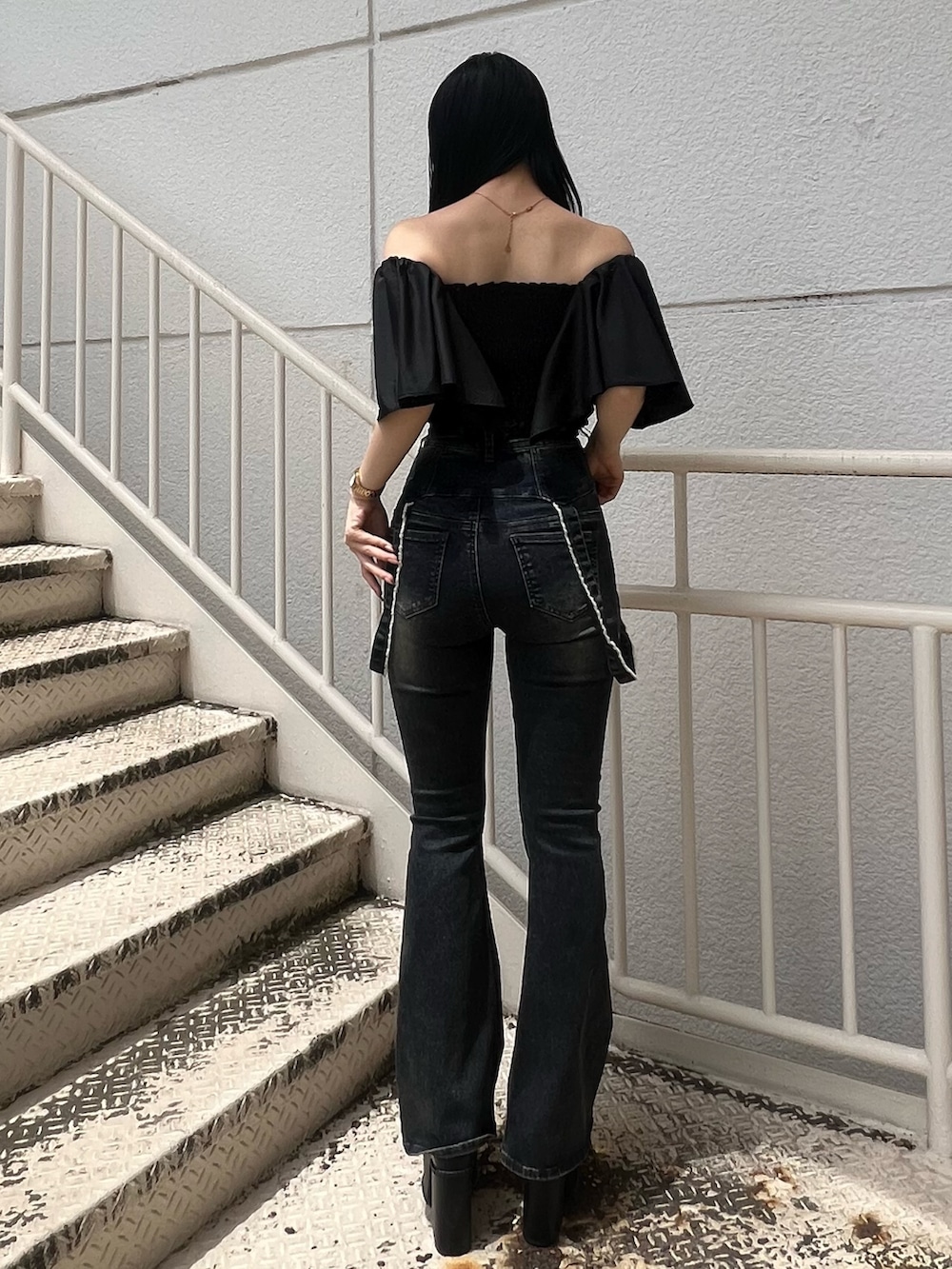 ブラック系のTシャツ/カットソー、ブルー系のデニムパンツ、ブラック系のサンダルを着用したレディースの夏コーディネートの3枚目の写真
