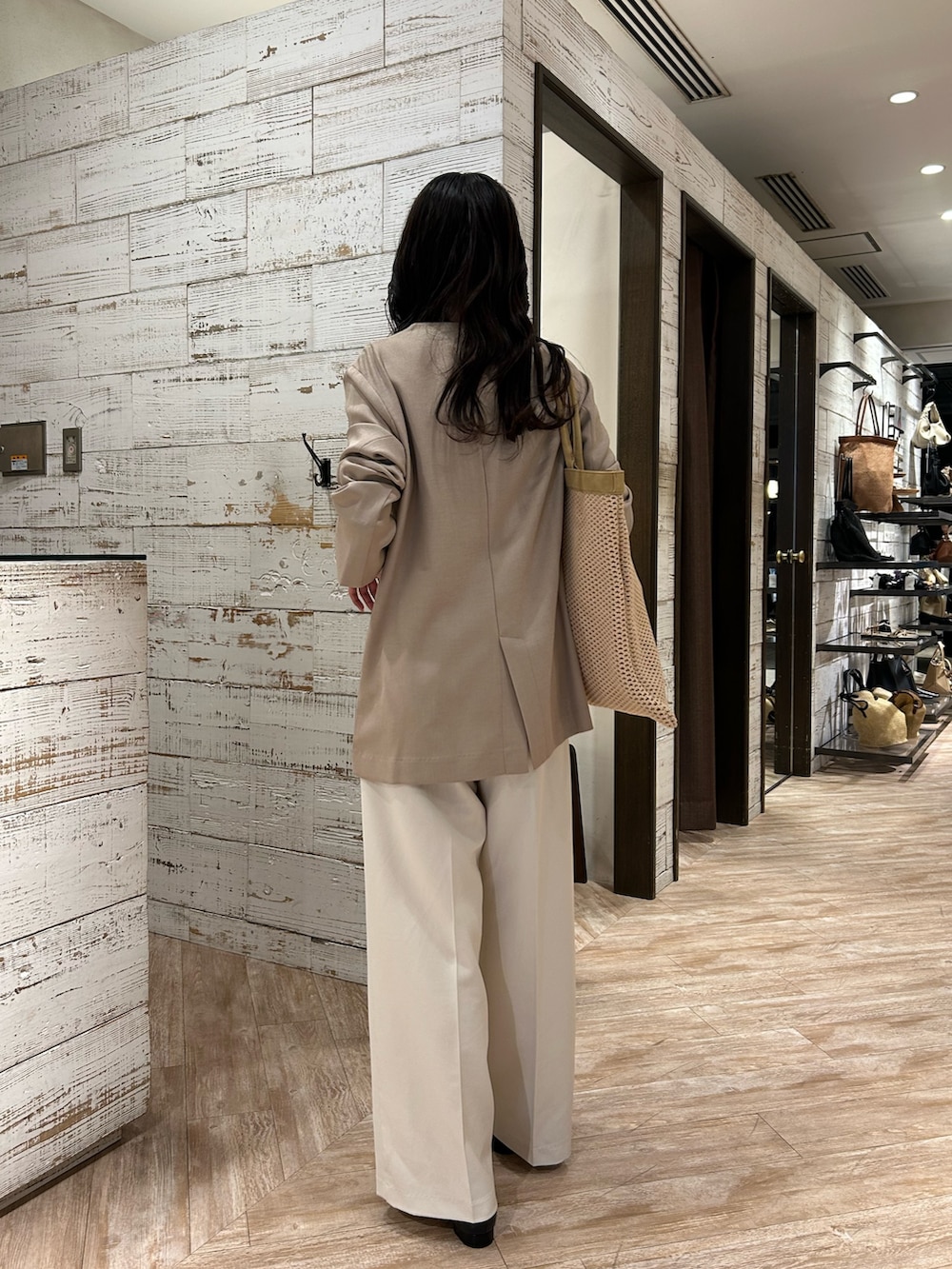 ベージュ系のその他アウター、ホワイト系のその他パンツ、ブラック系のパンプスを着用したレディースの春コーディネートの4枚目の写真