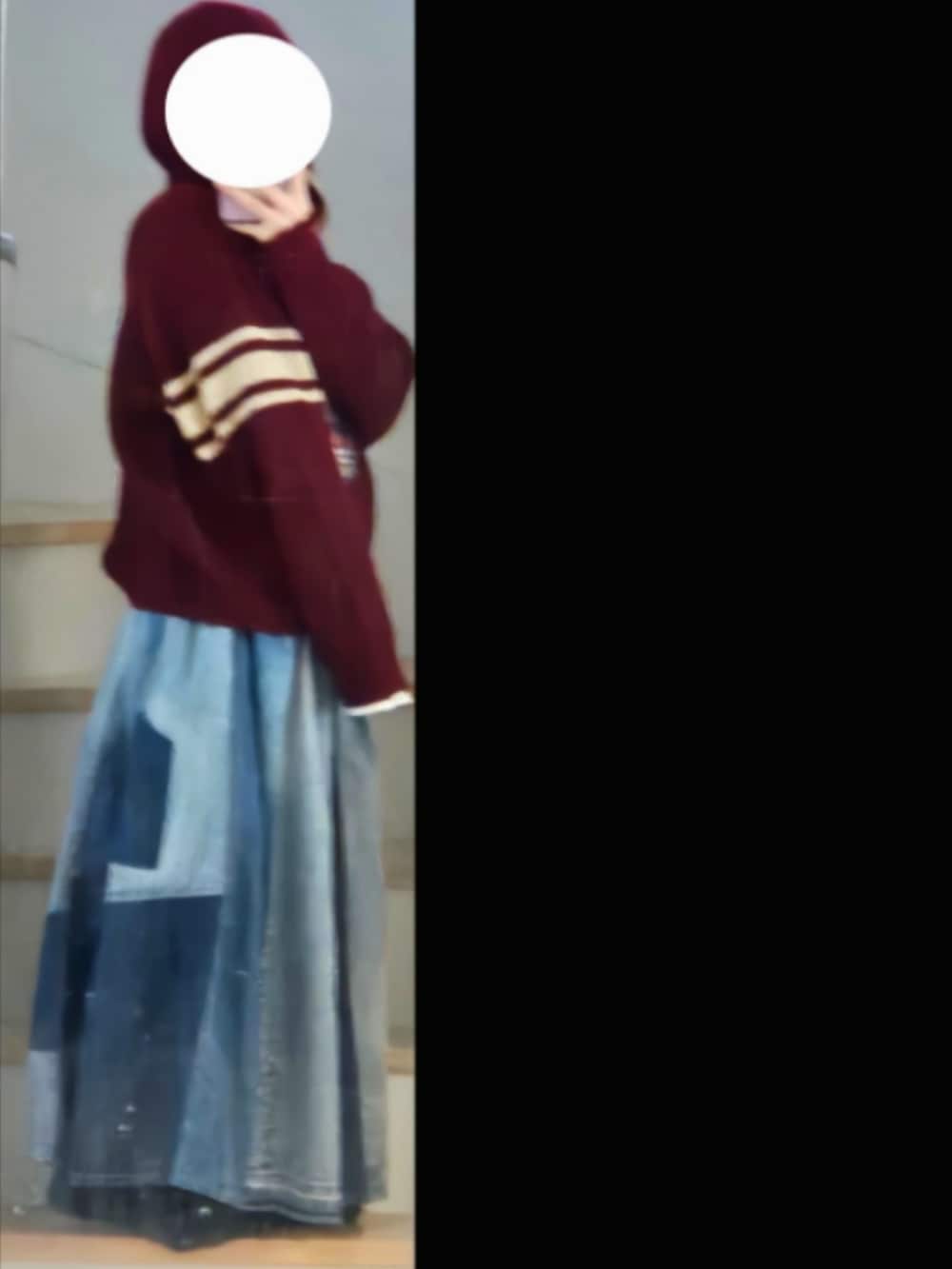 レッド系のニット/セーター、ホワイト系のタンクトップ、ブルー系のデニムスカートを着用したレディースの冬コーディネートの2枚目の写真