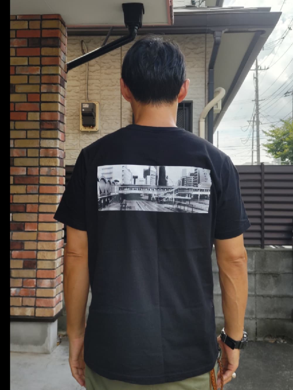 ブラック系のTシャツ/カットソー、グリーン系のカーゴパンツ、パープル系のスニーカーを着用したメンズの秋コーディネートの2枚目の写真