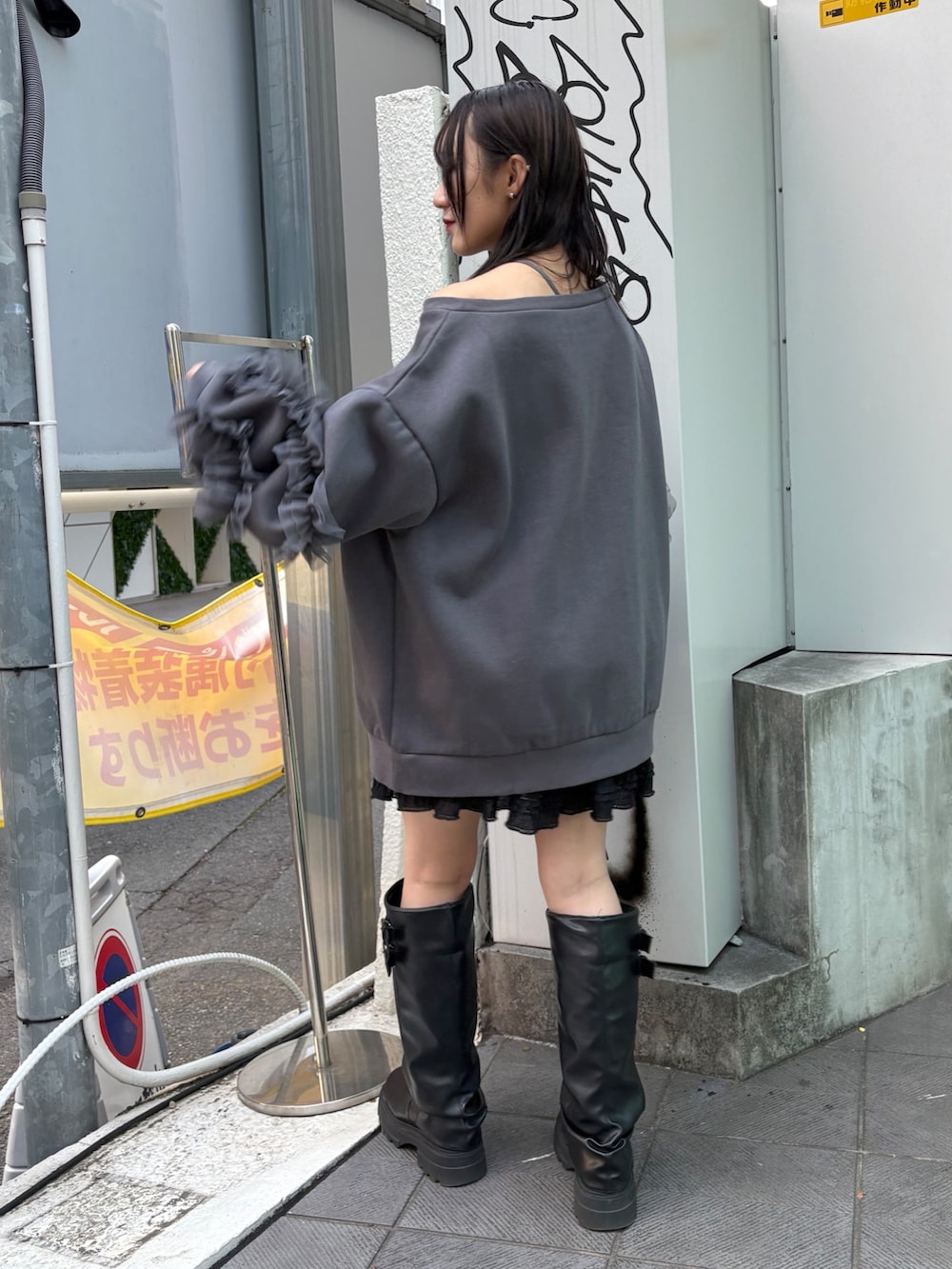 グレー系のTシャツ/カットソー、ブラック系のスカート、ブラック系のブーツを着用したレディースの冬コーディネートの5枚目の写真