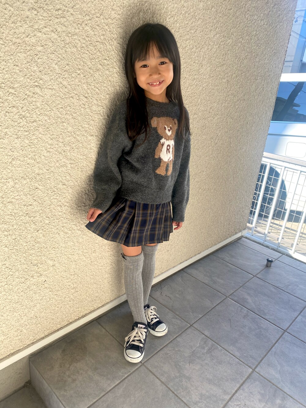 グレー系のニット/セーター、グリーン系のパンツ、ブラック系のスニーカーを着用したキッズの秋コーディネートの5枚目の写真