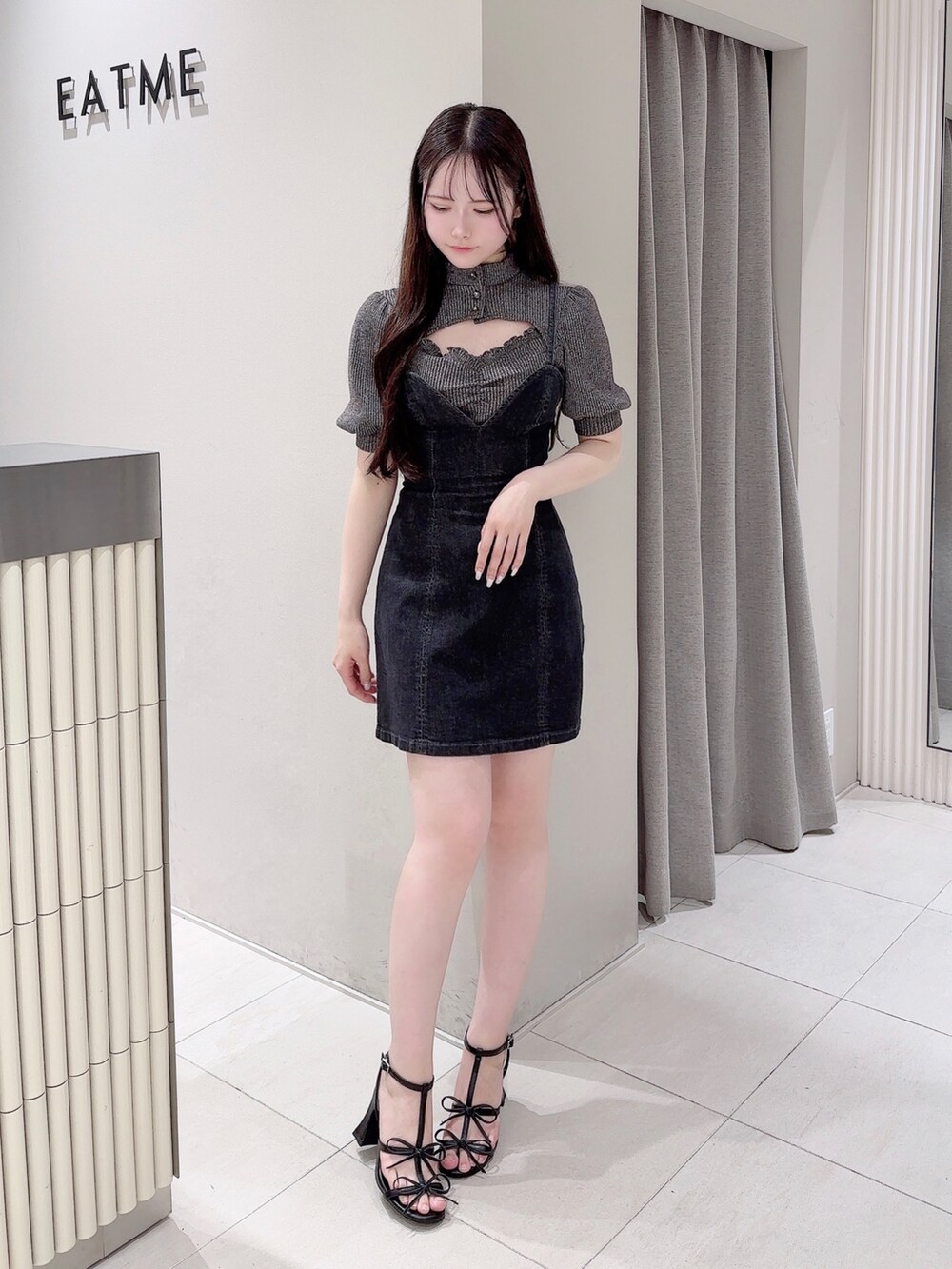 ブラック系のワンピース、ブラック系のサンダル、グレー系のTシャツ/カットソーを着用したレディースの夏コーディネートの2枚目の写真