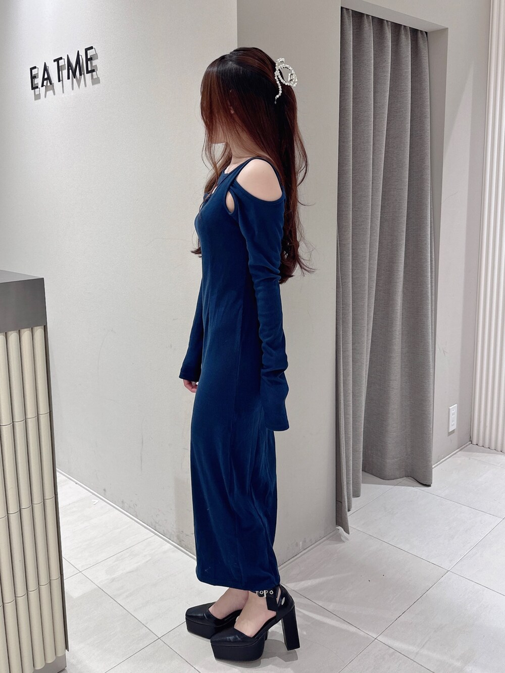 ブルー系のワンピース、ブラック系のパンプスを着用したレディースの秋コーディネートの2枚目の写真