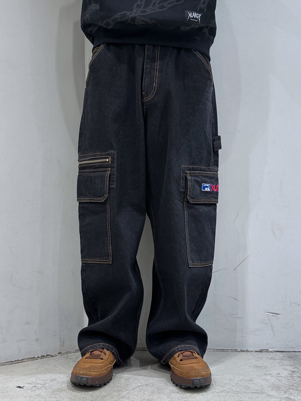 ブラック系のパーカー、ブラック系のデニムパンツ、ブラック系のハットを着用したメンズの春コーディネートの6枚目の写真