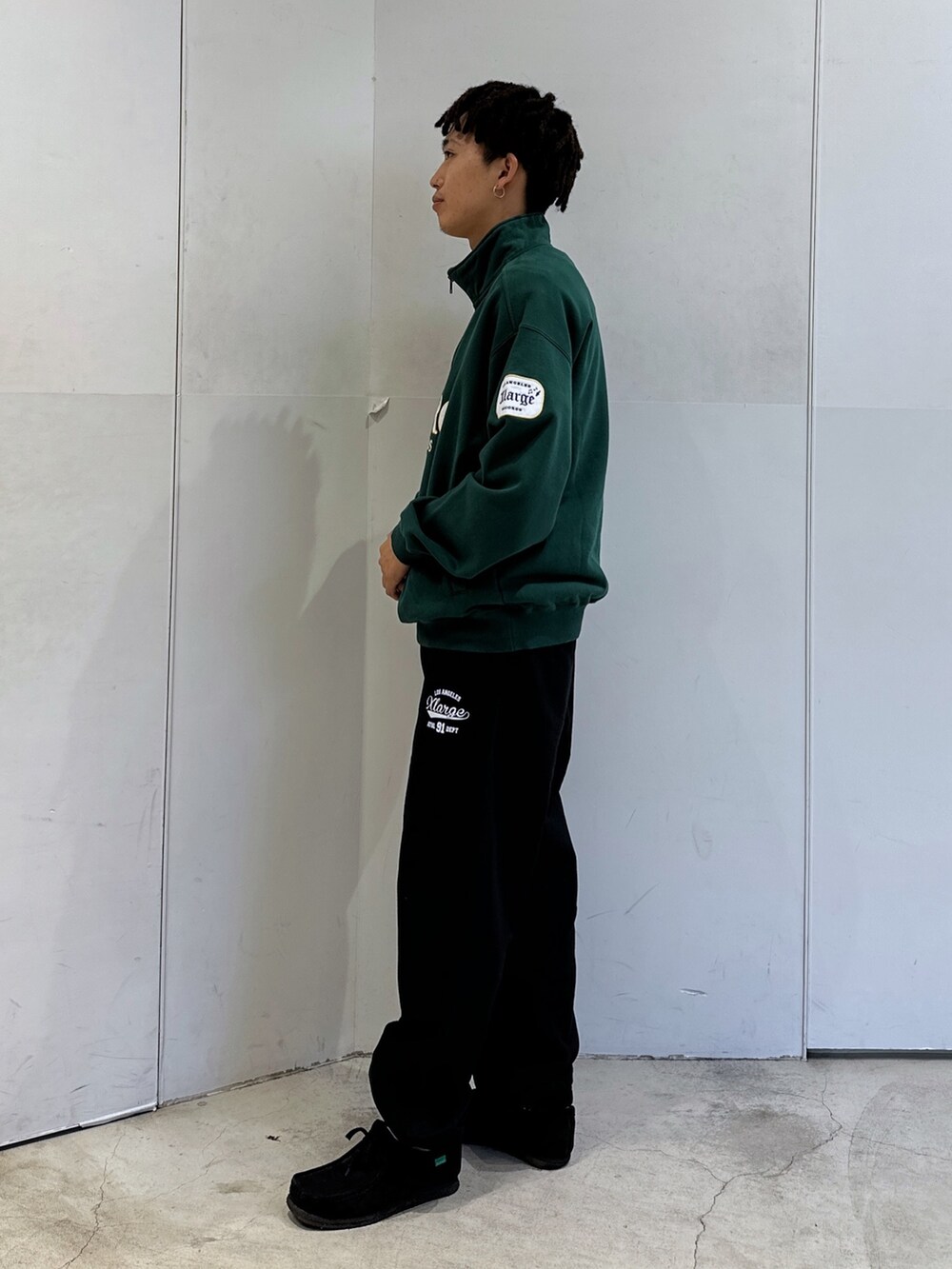 グリーン系のスウェット、ブラック系のスウェットパンツを着用したメンズの秋コーディネートの2枚目の写真