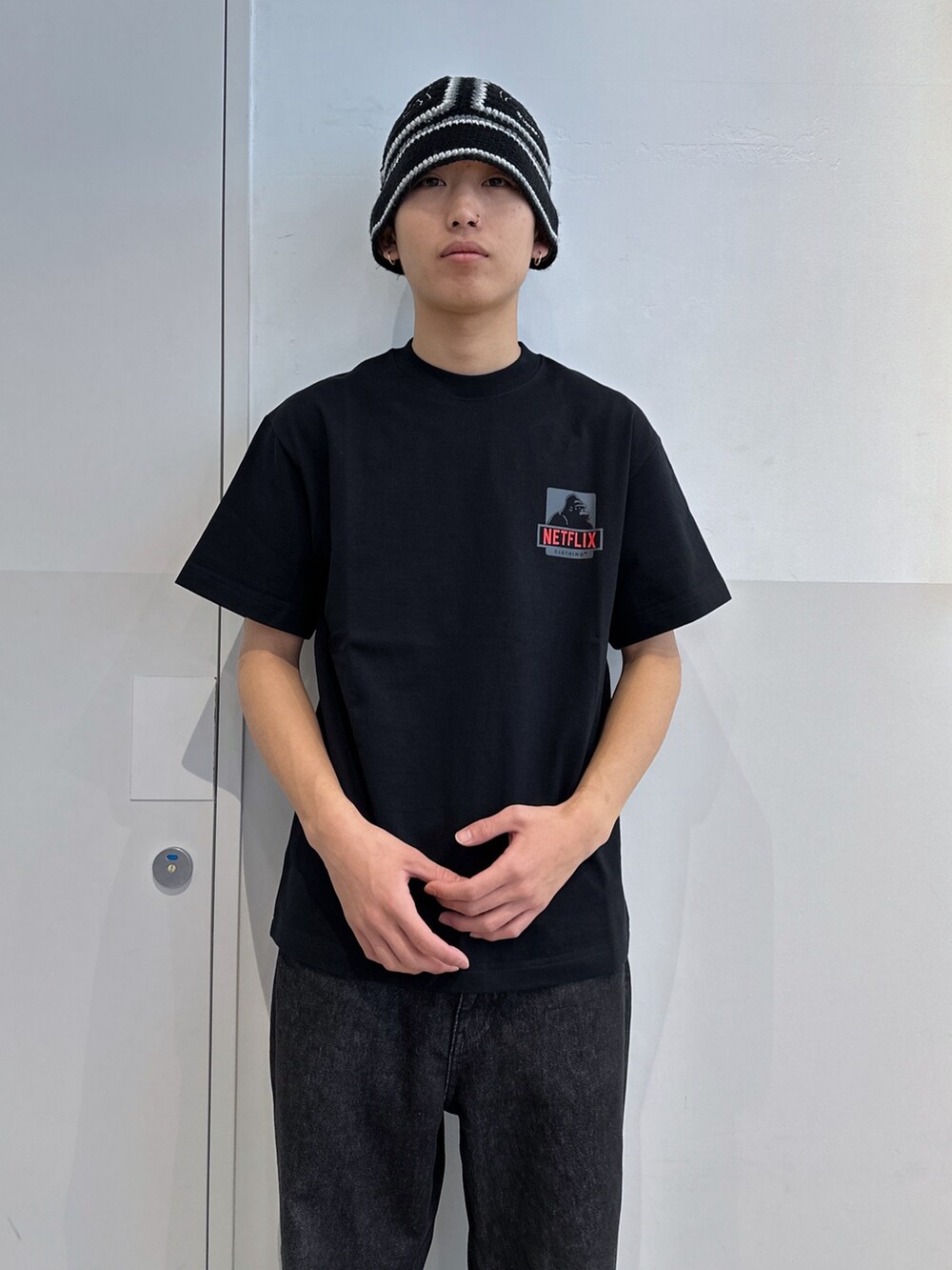 ブラック系のTシャツ/カットソー、ブラック系のデニムパンツ、ブラック系のハットを着用したメンズの冬コーディネートの5枚目の写真