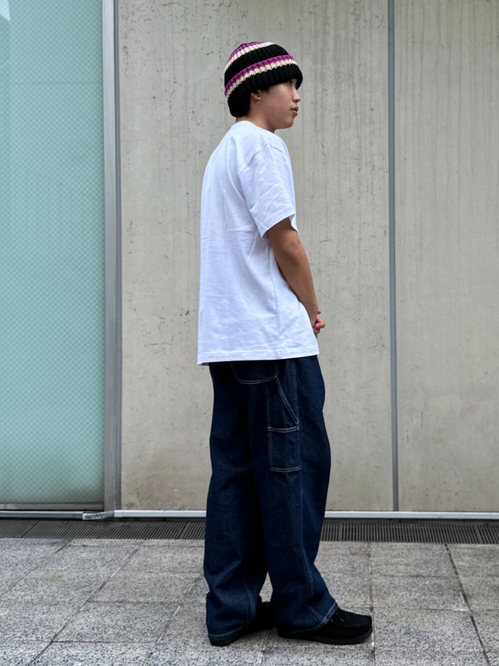 ホワイト系のTシャツ/カットソー、ブルー系のデニムパンツ、ブラック系のニットキャップ/ビーニーを着用したメンズの春コーディネートの4枚目の写真