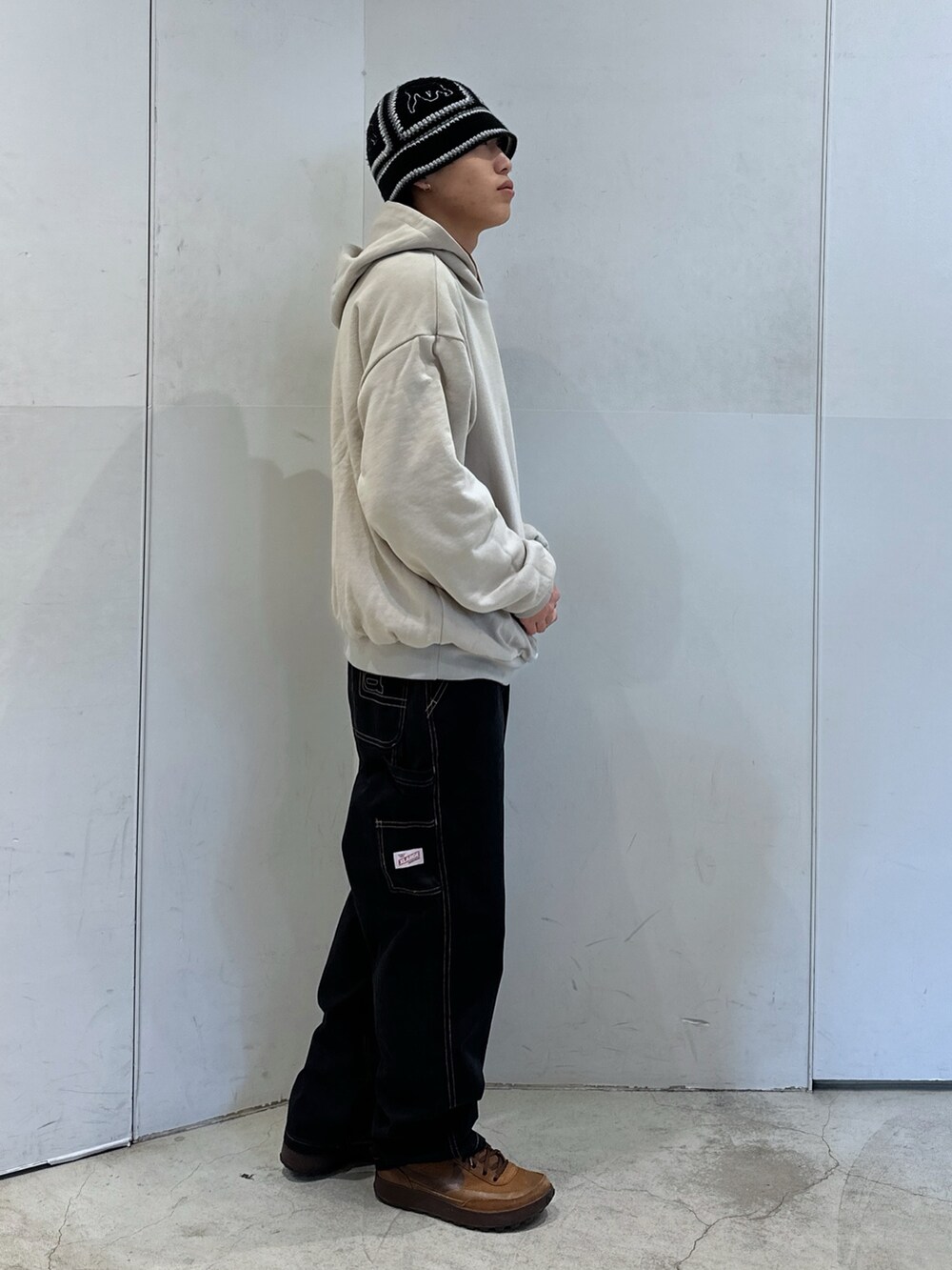 ブラウン系のパーカー、ブラック系のその他パンツ、ブラック系のハットを着用したメンズの冬コーディネートの4枚目の写真