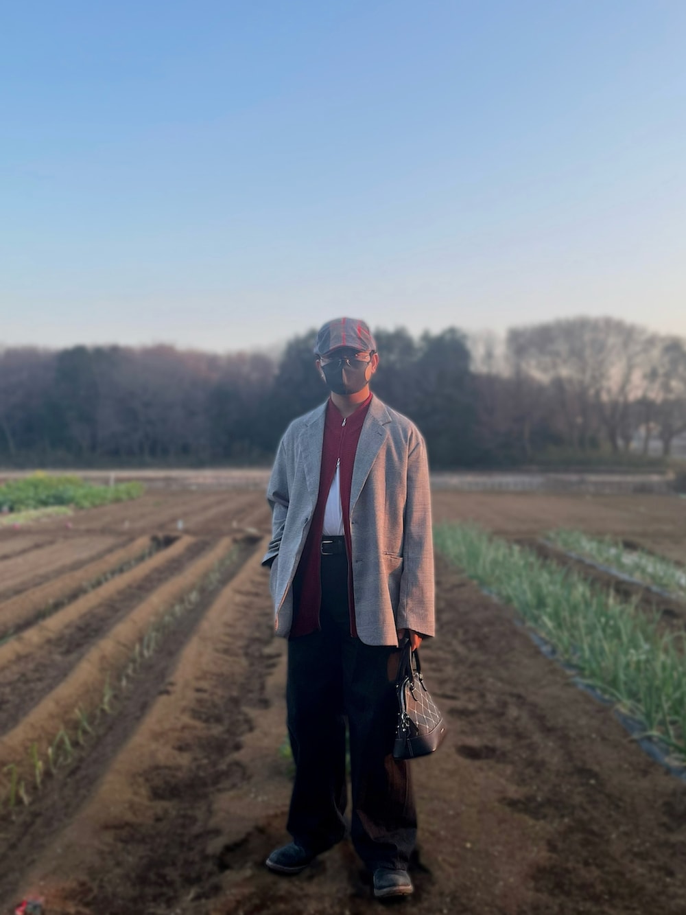 グレー系のテーラードジャケット、レッド系のベスト、ホワイト系のTシャツ/カットソーを着用したメンズの春コーディネートの4枚目の写真