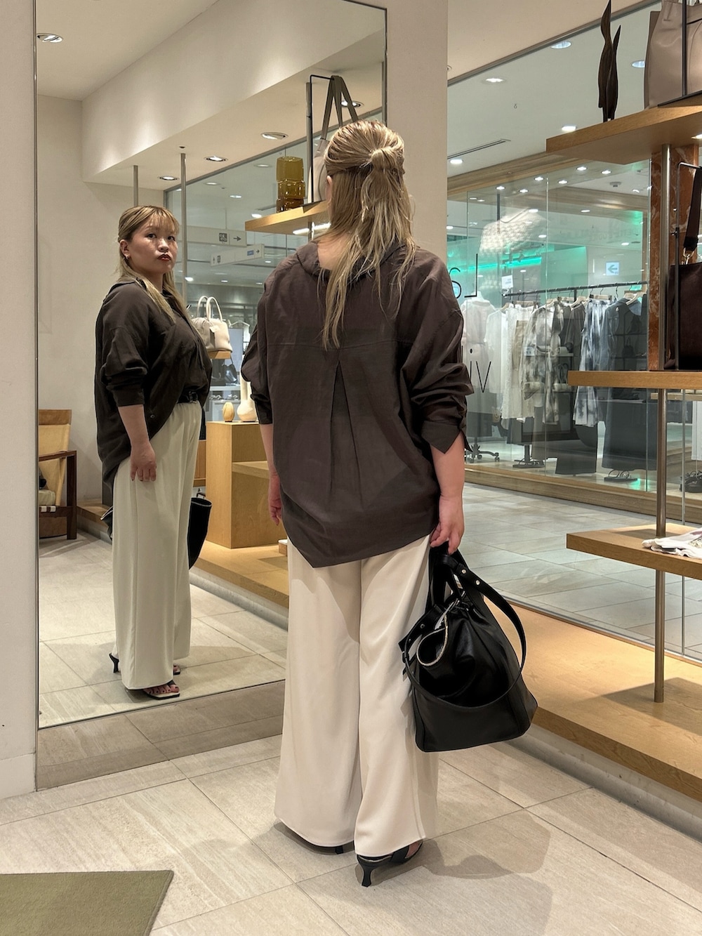 グレー系のシャツ/ブラウス、ベージュ系のその他パンツ、ブラック系のハンドバッグを着用したレディースの夏コーディネートの2枚目の写真