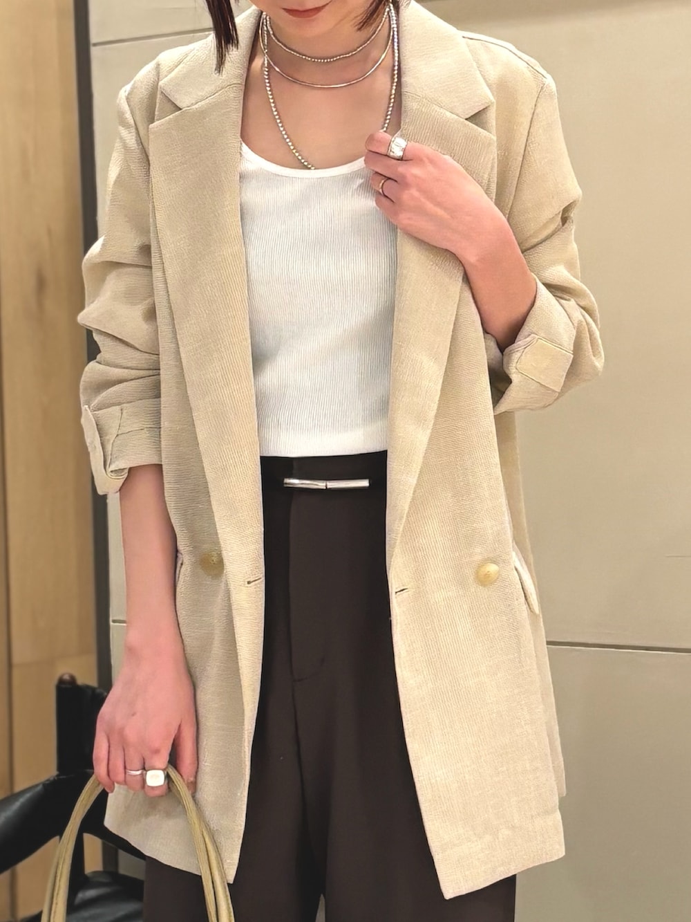 ブラウン系のその他パンツ、ブラウン系のパンプス、ベージュ系のトートバッグを着用したレディースの春コーディネートの3枚目の写真