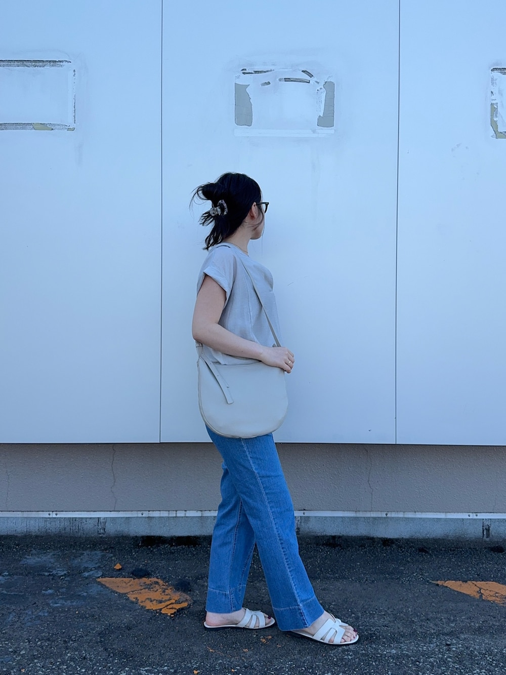 グレー系のシャツ/ブラウス、ブルー系のデニムパンツを着用したレディースの夏コーディネートの4枚目の写真