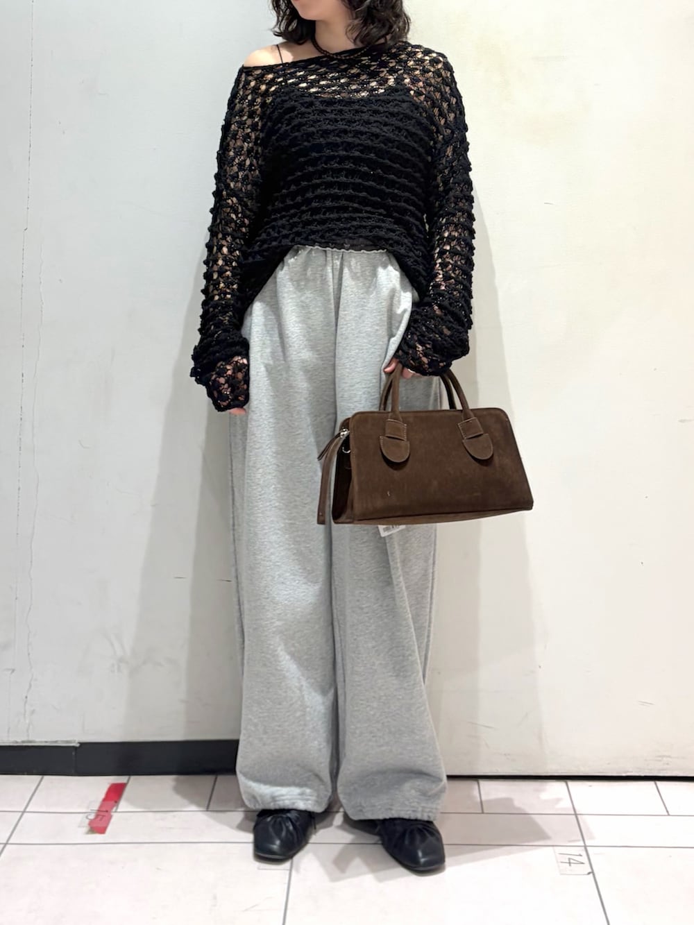 ブラック系のニット/セーター、グレー系のその他パンツ、ブラック系のその他シューズを着用したレディースの春コーディネートの3枚目の写真