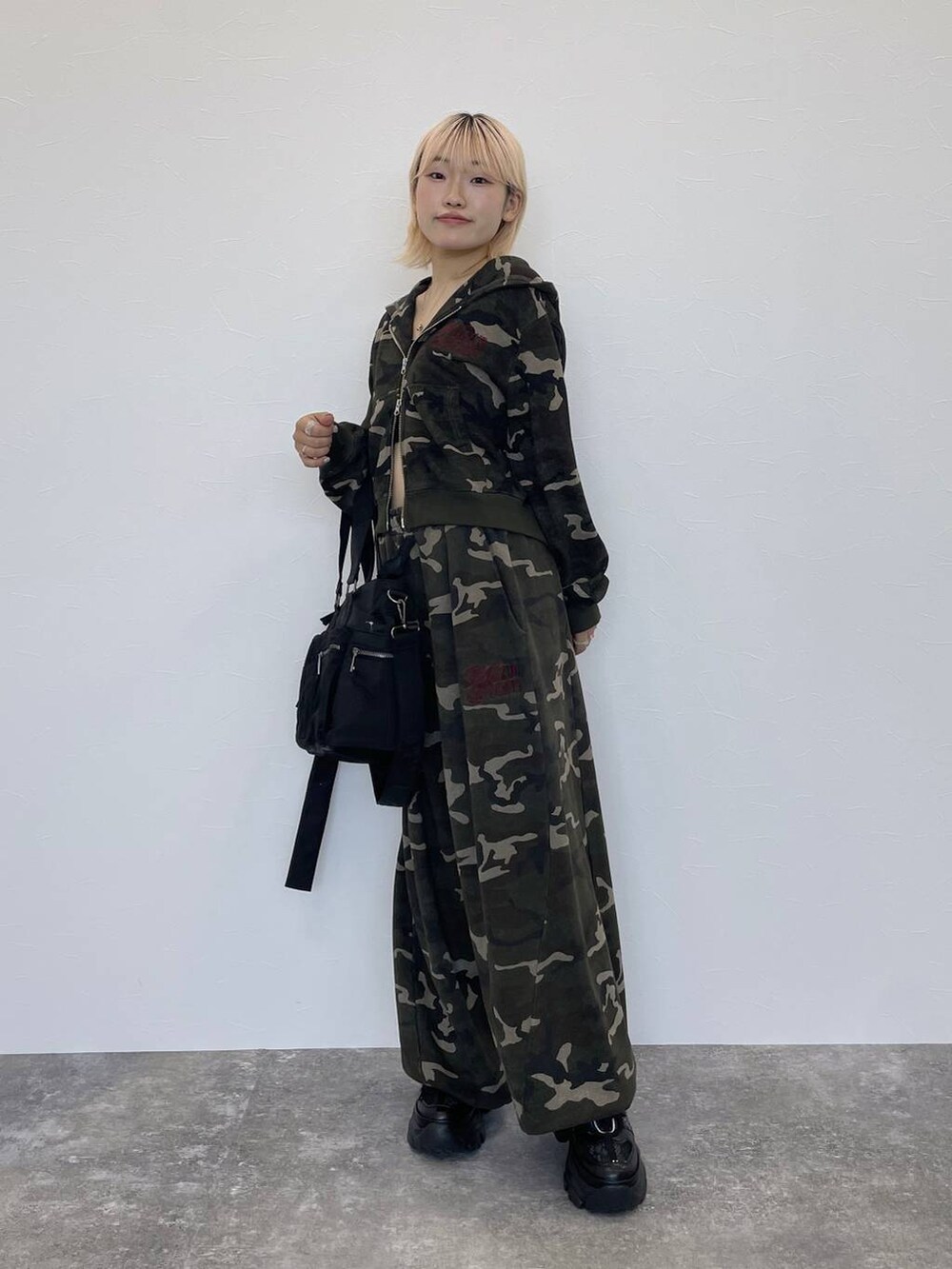 ブラック系のスニーカー、ブラック系のキャミソール、その他のスウェットパンツを着用したレディースの秋コーディネートの5枚目の写真