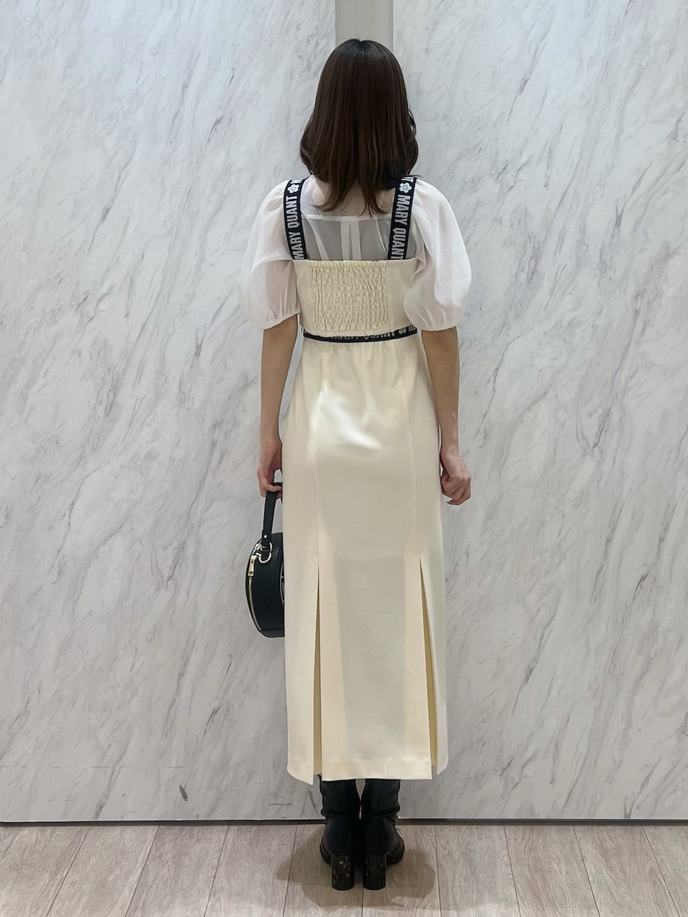 ホワイト系のシャツ/ブラウス、ホワイト系のスカート、ブラック系のショルダーバッグを着用したレディースの冬コーディネートの5枚目の写真