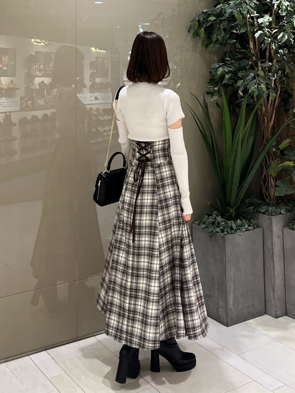 ホワイト系のニット/セーター、ブラウン系のテーラードジャケット、ブラウン系のスカートを着用したレディースの秋コーディネートの8枚目の写真