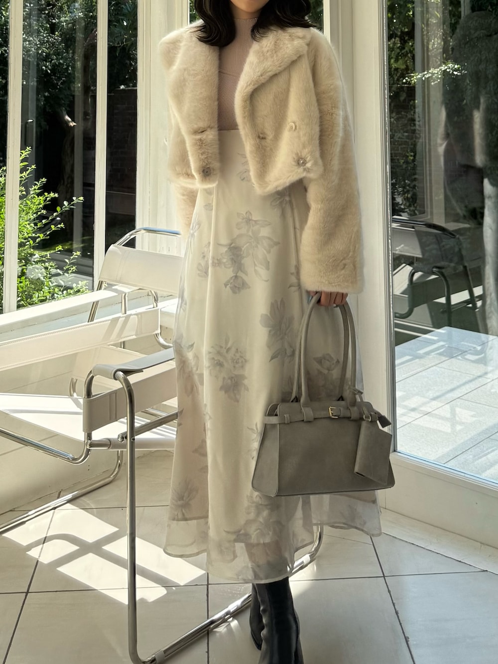 ベージュ系のワンピース、グレー系のハンドバッグ、ブラック系のブーツを着用したレディースの秋コーディネートの6枚目の写真