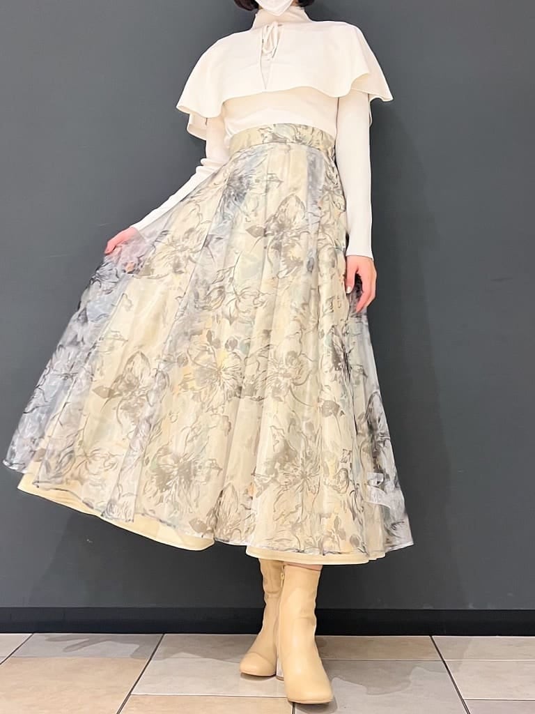 ベージュ系のブーツ、グリーン系のスカート、ホワイト系のニット/セーターを着用したレディースの秋コーディネートの8枚目の写真