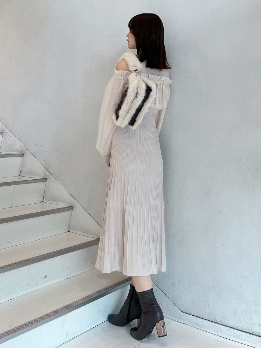 ホワイト系のワンピース、ブラウン系のショルダーバッグ、ブラウン系のブーツを着用したレディースの秋コーディネートの4枚目の写真