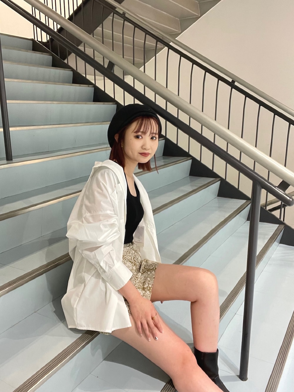 イエロー系のスカート、ホワイト系のシャツ/ブラウス、ブラック系のタンクトップを着用したレディースの夏コーディネートの2枚目の写真