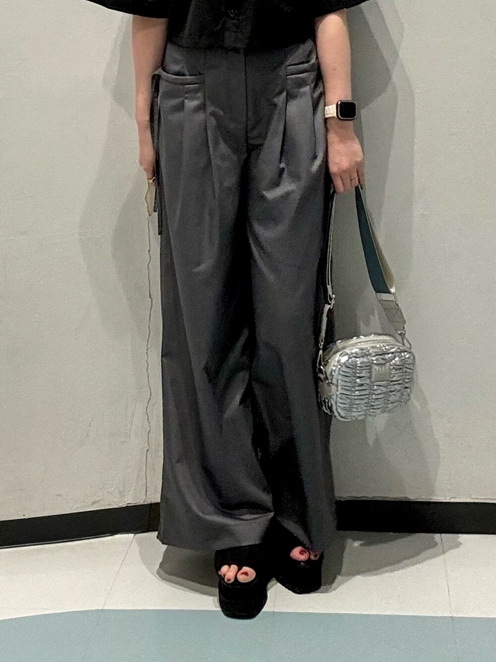 シルバー系のショルダーバッグ、ブラック系のシャツ/ブラウス、グレー系のその他パンツを着用したレディースの春コーディネートの5枚目の写真