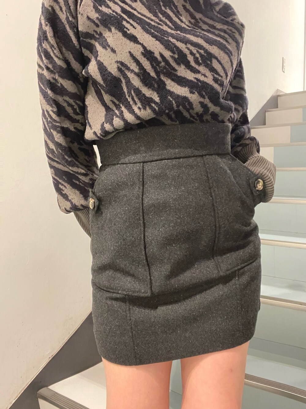 グレー系のテーラードジャケット、グレー系のニット/セーター、グレー系のスカートを着用したレディースの秋コーディネートの6枚目の写真