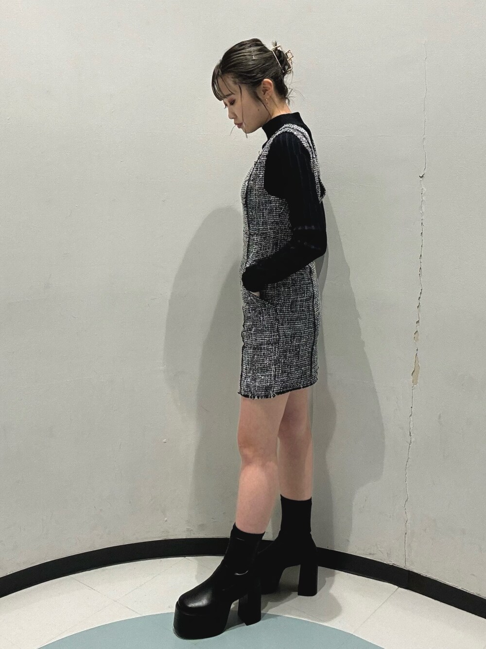 ブラック系のハンドバッグ、ブラック系のニット/セーター、ブラック系のワンピースを着用したレディースの冬コーディネートの3枚目の写真