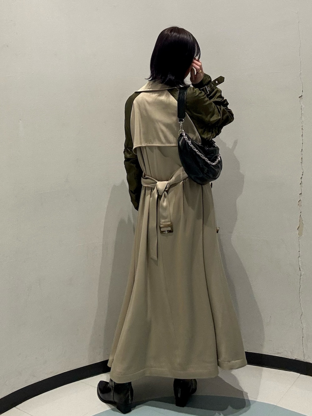 ブラック系のショルダーバッグ、ブラック系のブーツ、ブルー系のワンピースを着用したレディースの冬コーディネートの3枚目の写真