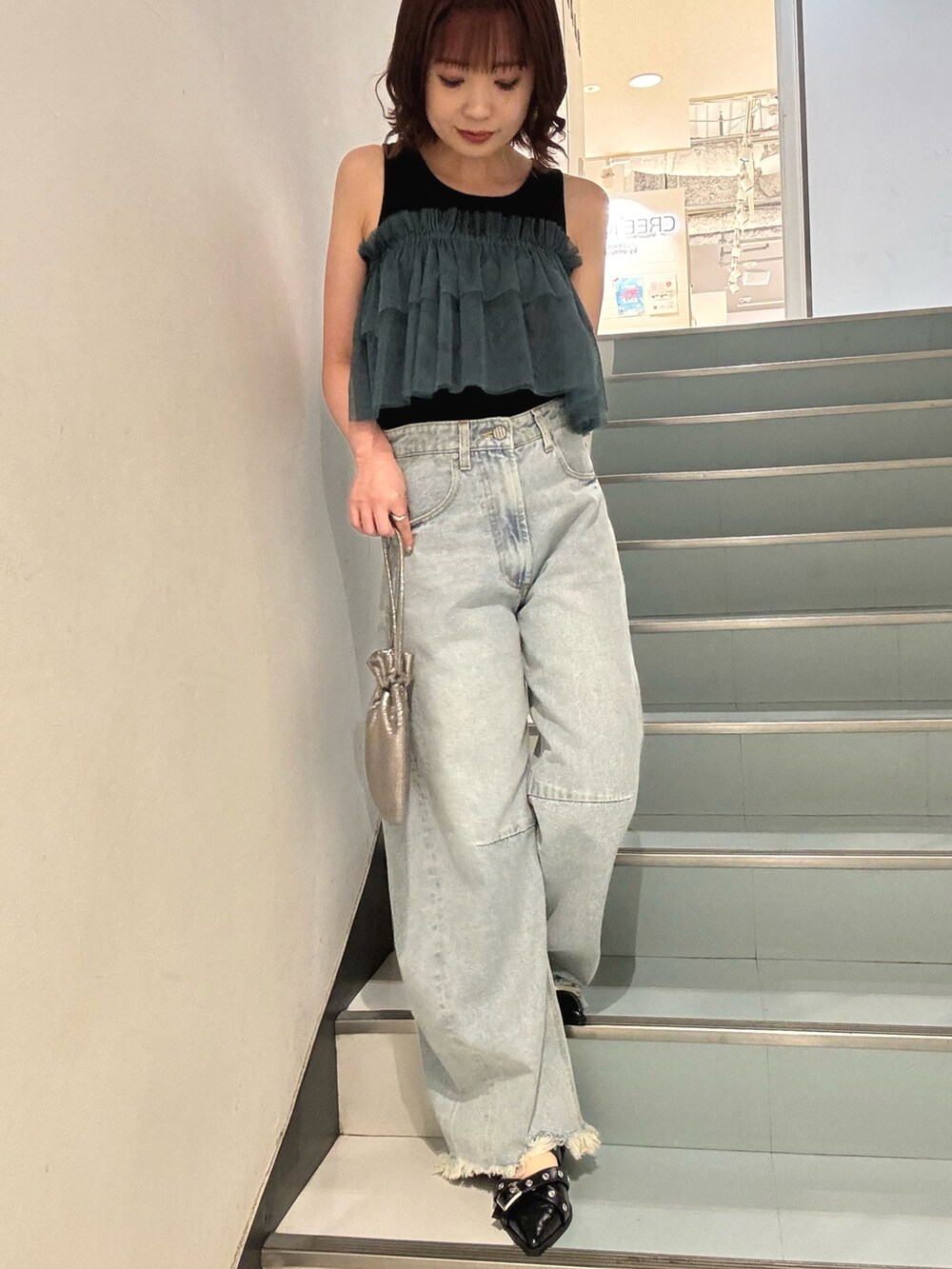 ブラック系のTシャツ/カットソー、ブルー系のデニムパンツ、ブラック系のパンプスを着用したレディースの夏コーディネートの5枚目の写真