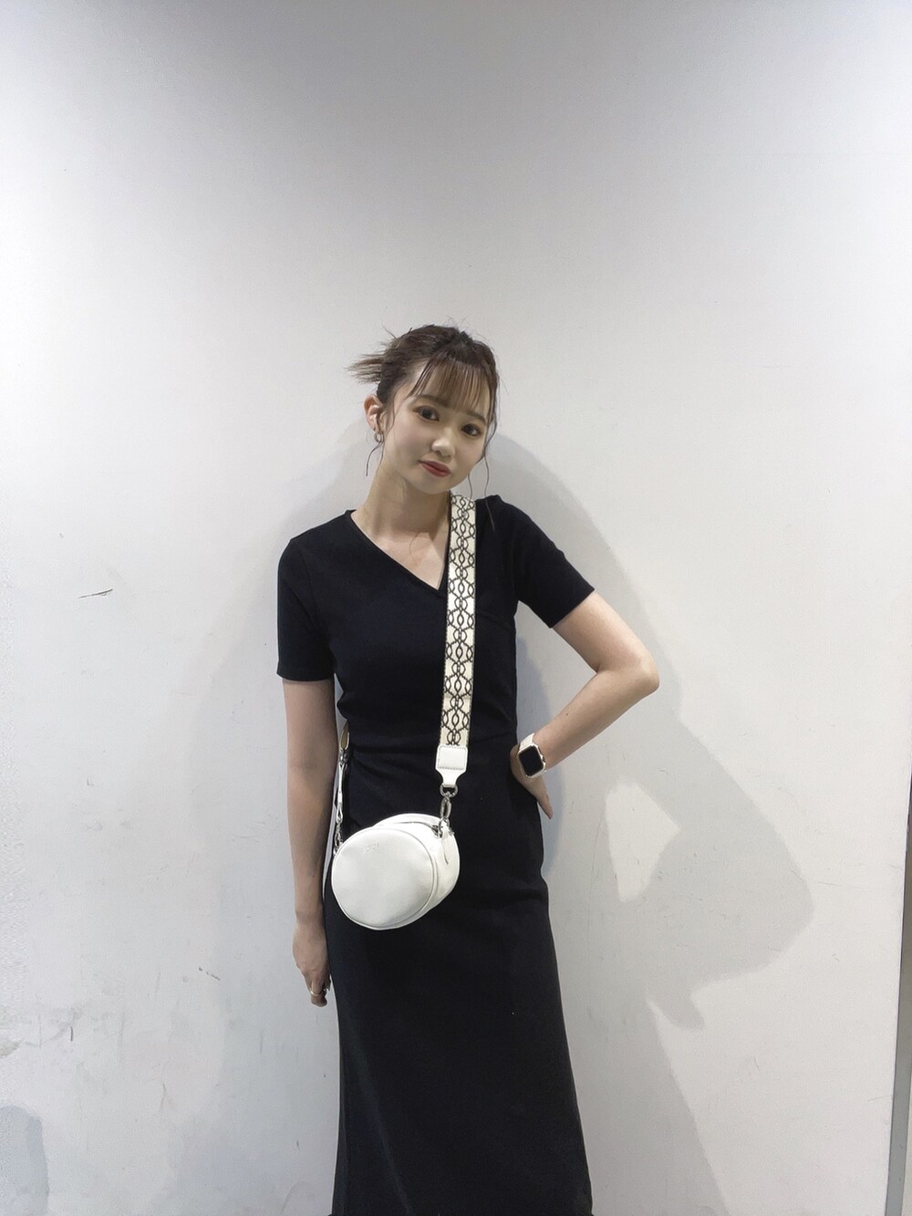 ブラック系のワンピース、ホワイト系のショルダーバッグを着用したレディースの夏コーディネートの2枚目の写真