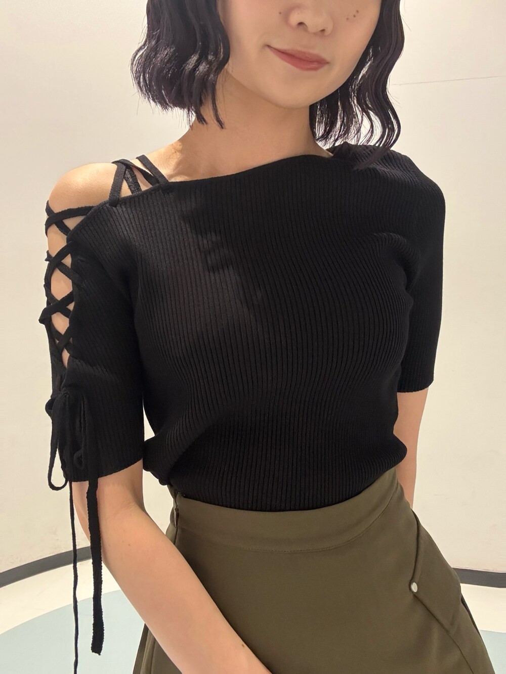 シルバー系のハンドバッグ、ブラック系のサンダル、ブラック系のニット/セーターを着用したレディースの夏コーディネートの4枚目の写真