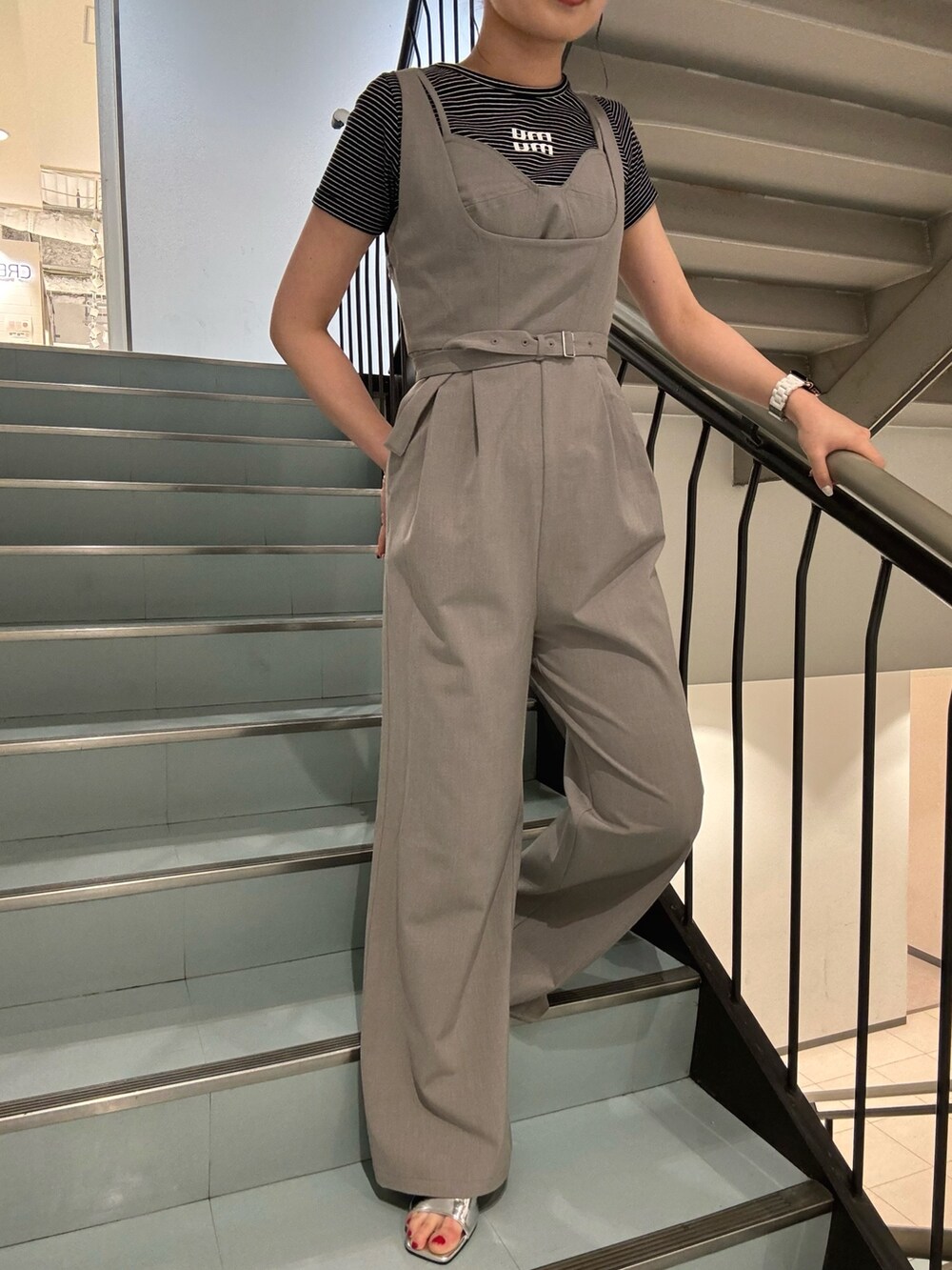 グレー系のワンピース、ブラック系のショルダーバッグ、シルバー系のサンダルを着用したレディースの春コーディネートの5枚目の写真