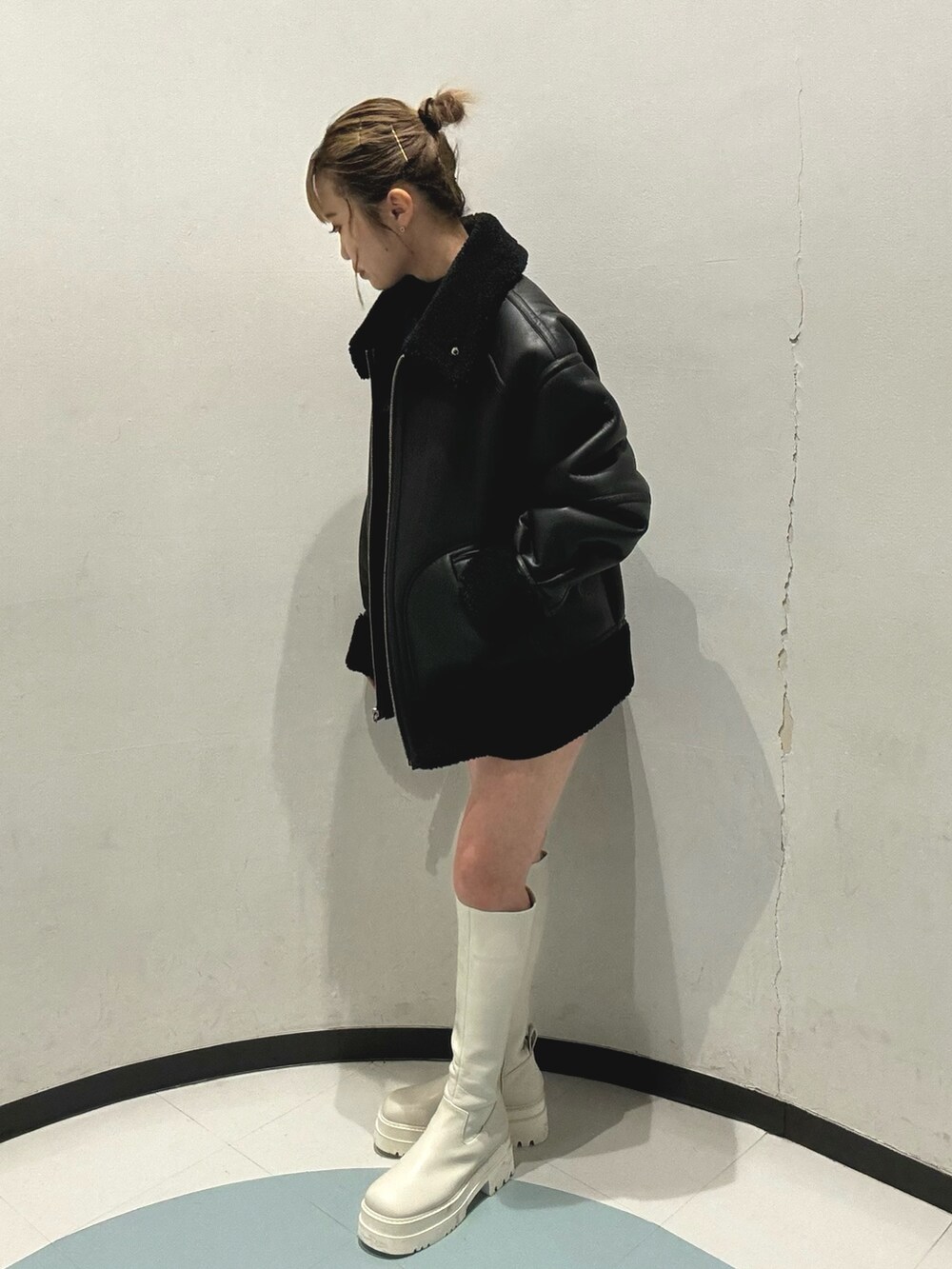 ブラック系のムートンコート、ブラック系のその他パンツ、ホワイト系のブーツを着用したレディースの秋コーディネートの2枚目の写真