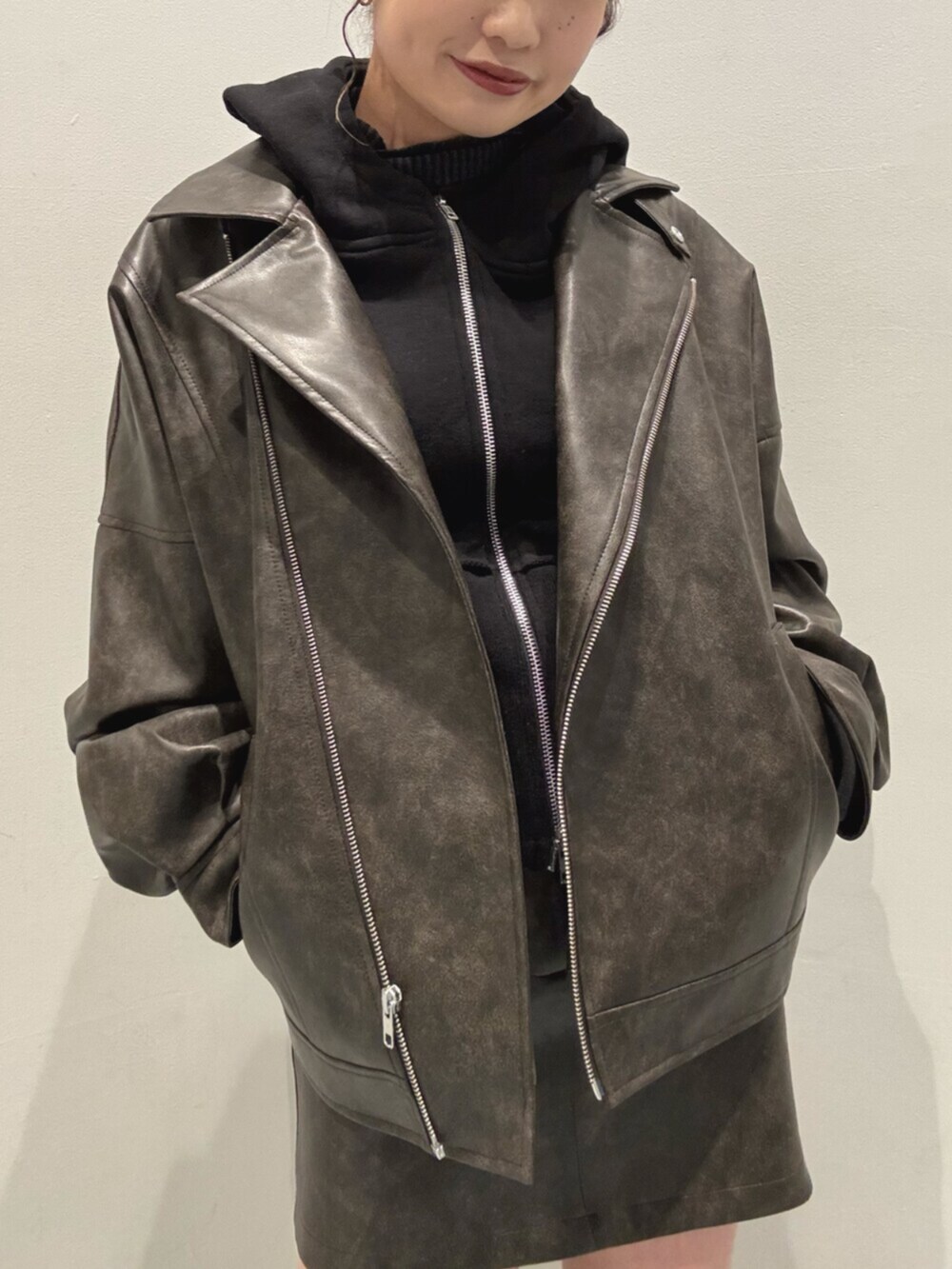 ブラック系のブーツ、ブラック系のパーカー、ブラウン系のブルゾンを着用したレディースの冬コーディネートの5枚目の写真